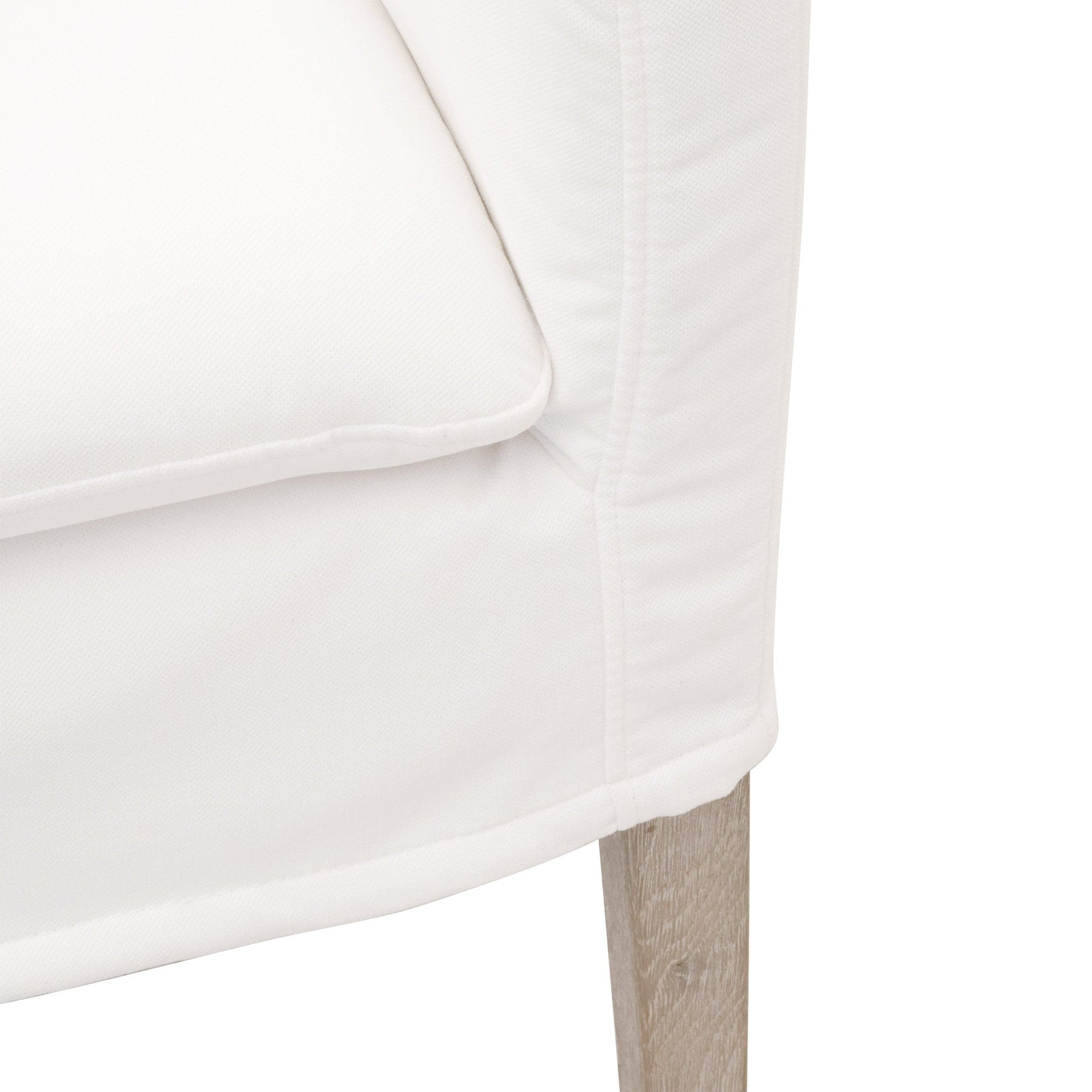 Close-up of Drake Slipcover Arm Chair in Peyton Pearl fabric with natural gray oak base by Essentials For Living