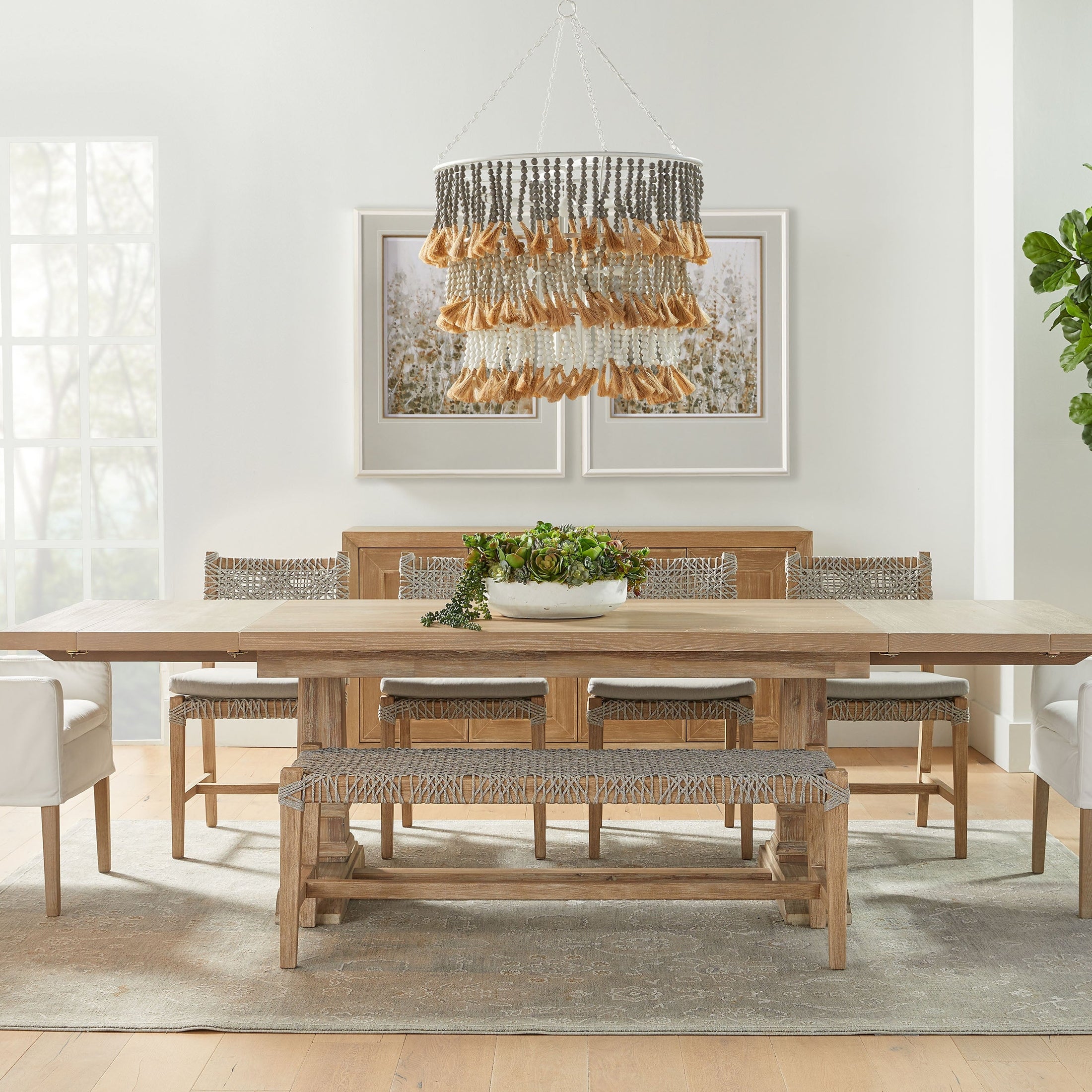 Image of a dining room with natural wood table and chairs, featuring the Drake Slipcover Arm Chair by Essentials for Living.