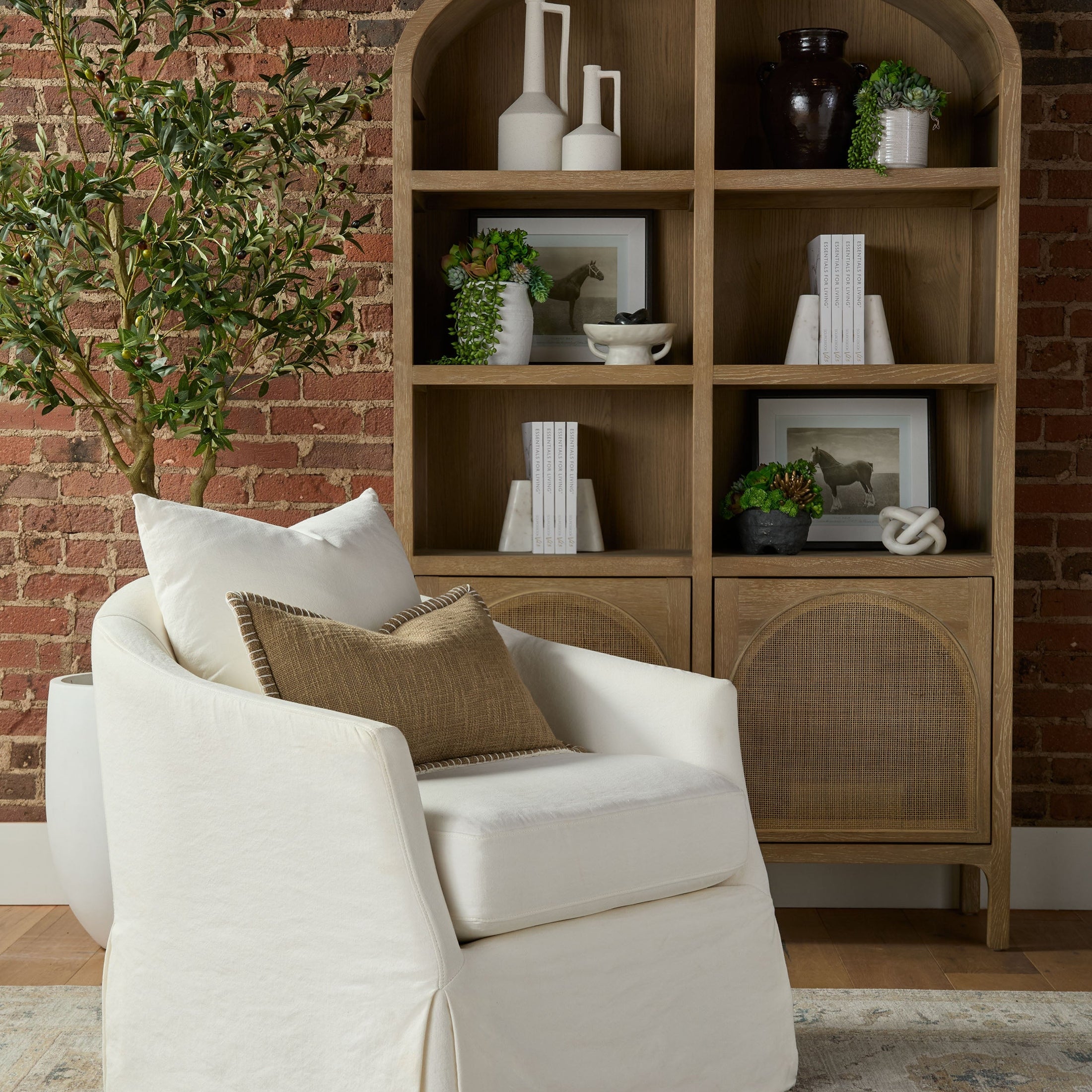 Essentials for Living Faye Slipcover Swivel Club Chair in crème crepe cotton and linen with throw pillows in cozy living room setting