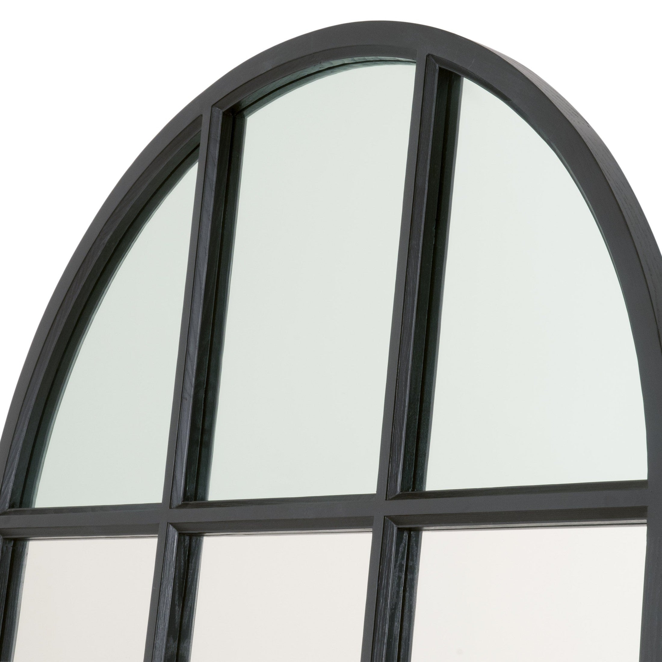 Close-up view of a black framed grid arched mirror with vertical and horizontal panels reflecting light