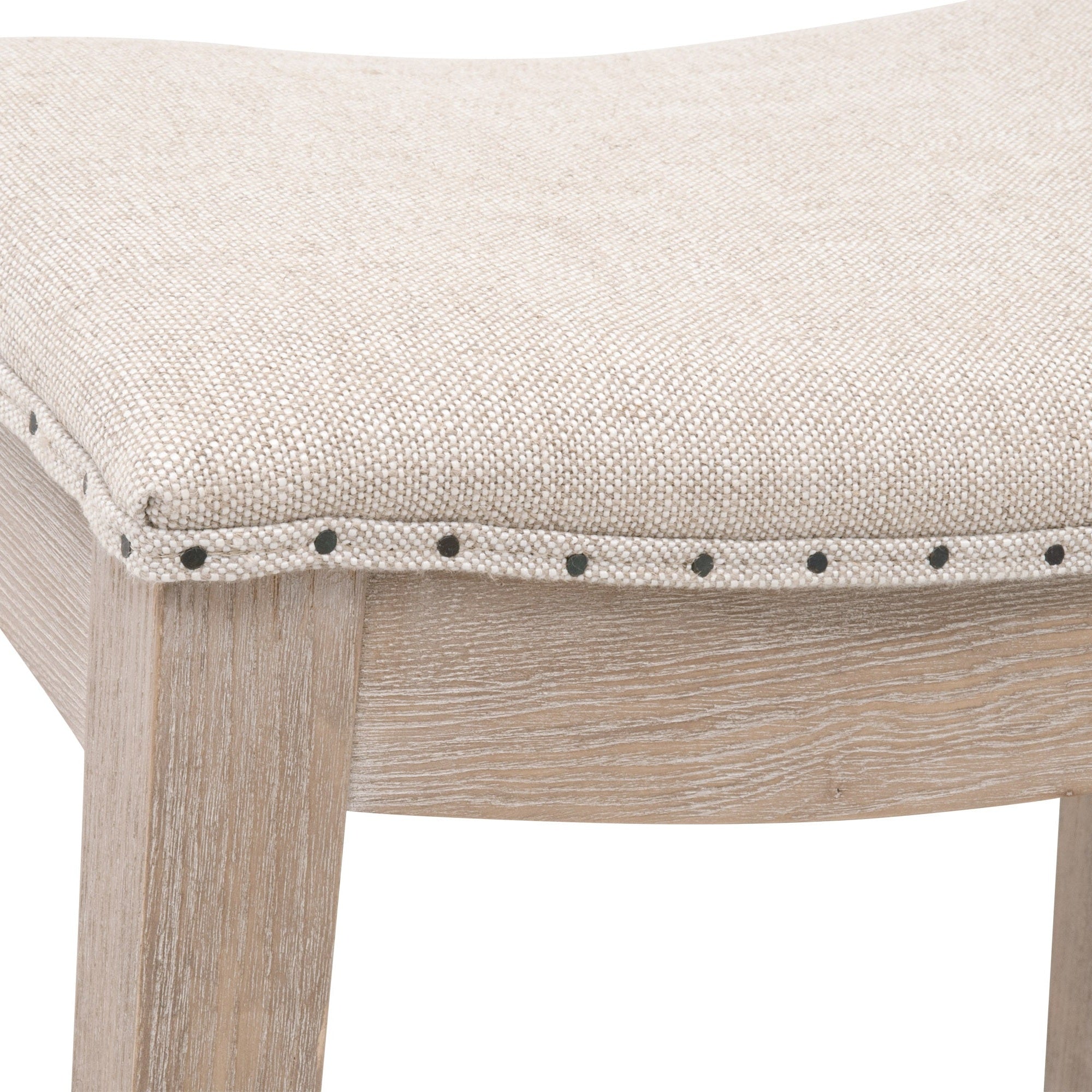 Close-up of Harper Counter Stool seat in bisque French linen with nail tack trim on natural gray ash frame by Essentials for Living