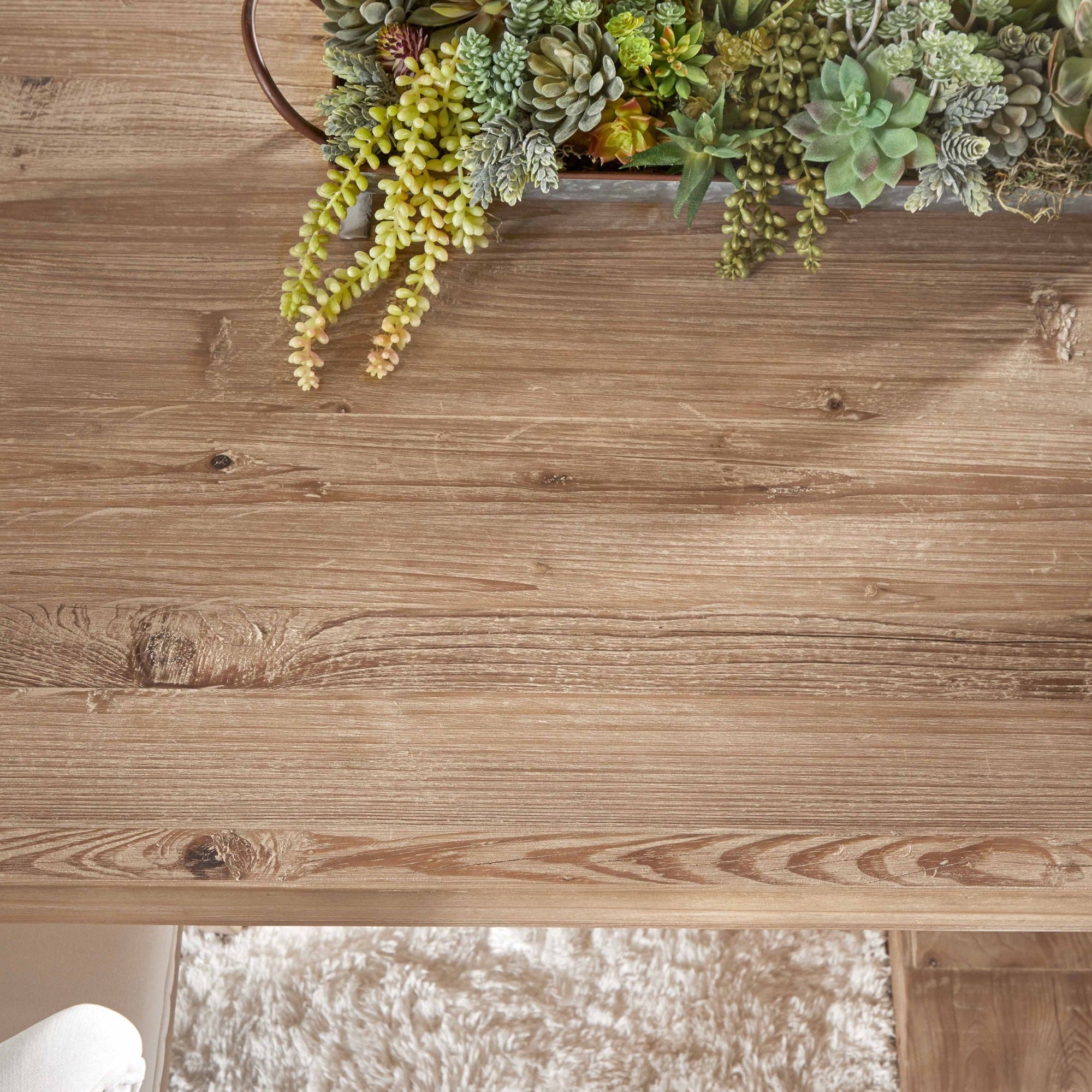 Close-up of reclaimed pine wood surface on Hayes Extension Dining Table with succulent centerpiece by Essentials For Living