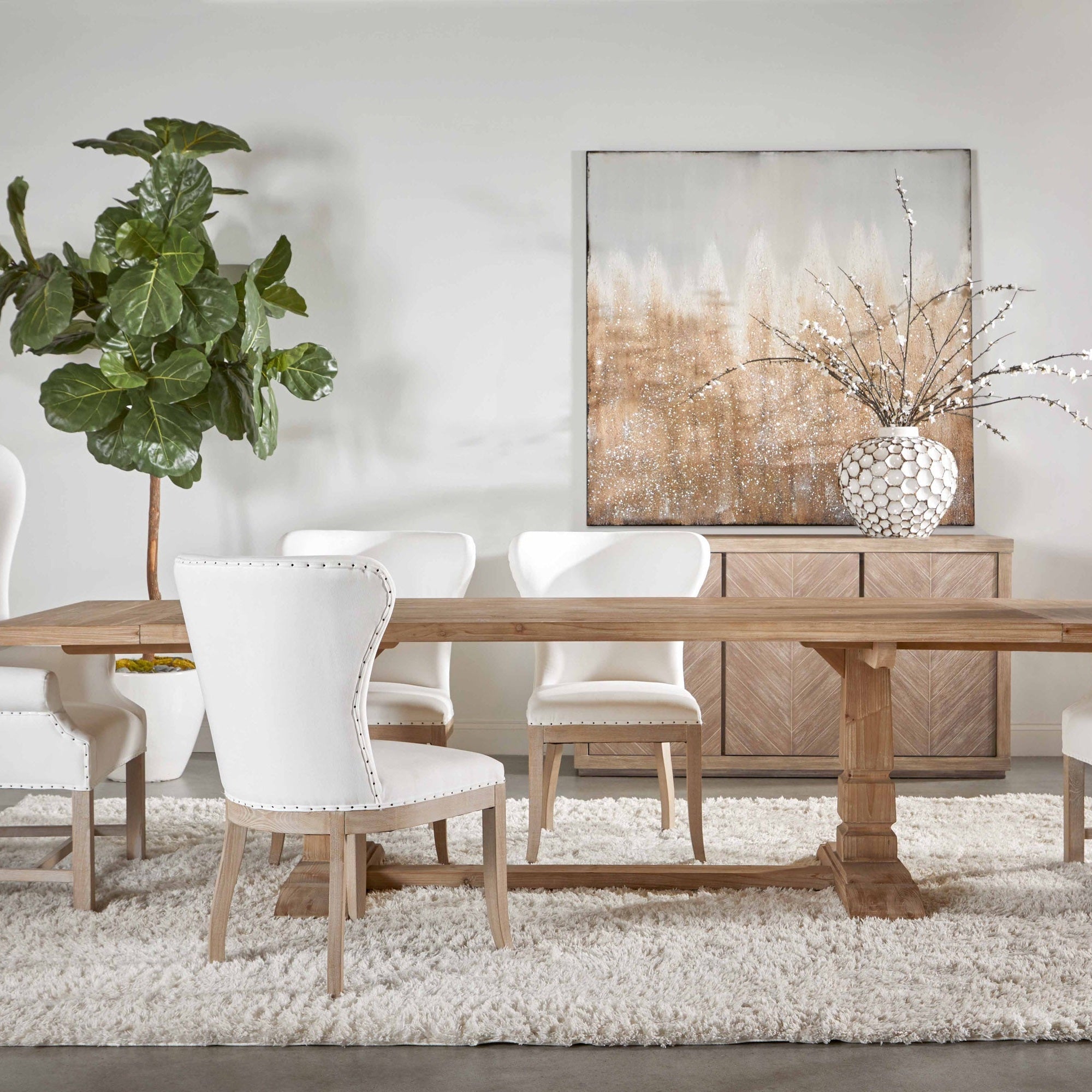 Hayes Extension Dining Table in reclaimed pine wood with trestle base and white chairs in dining room Essentials for Living