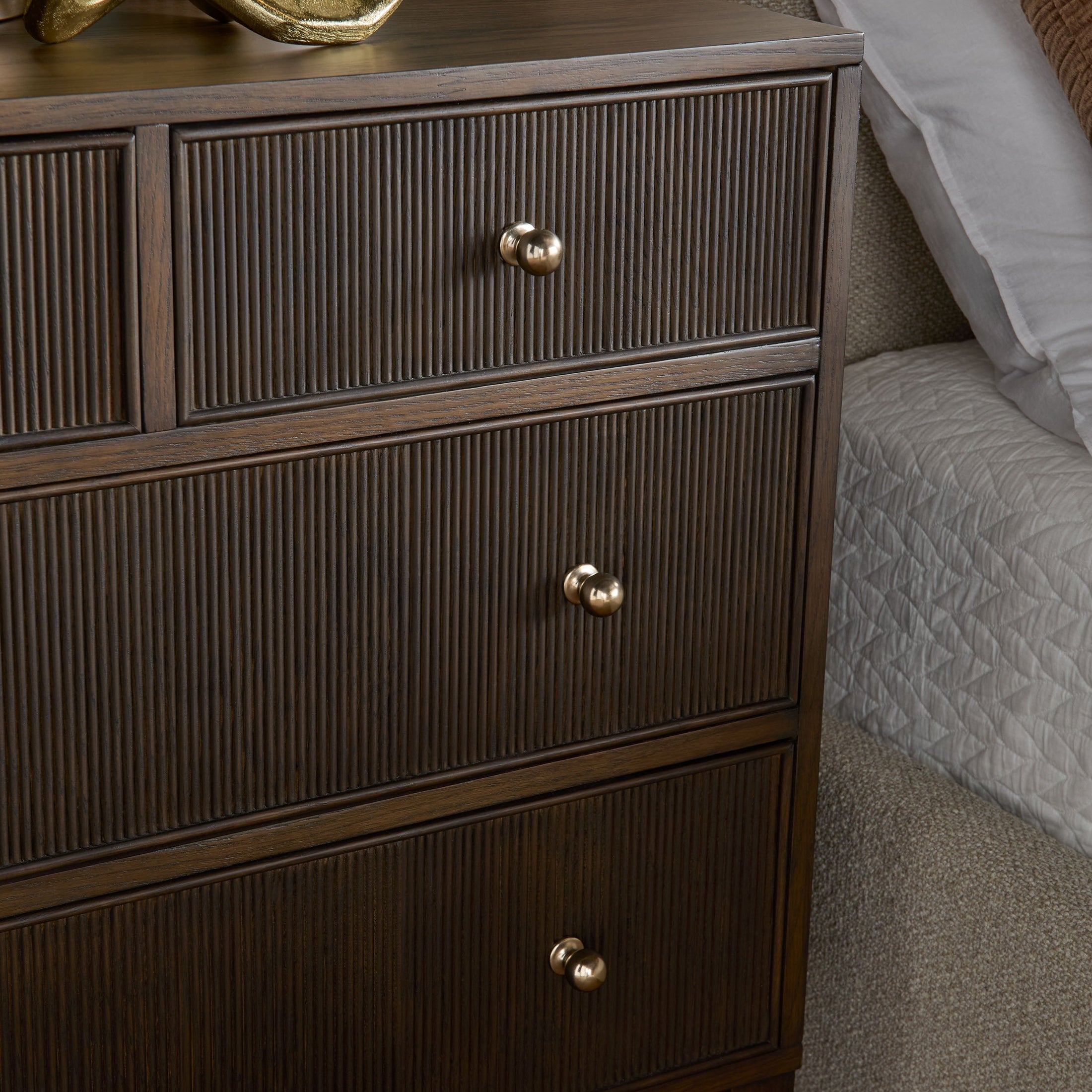 Close-up of Essentials For Living Highland dresser with fluted wood drawers and polished brass-finished iron knobs