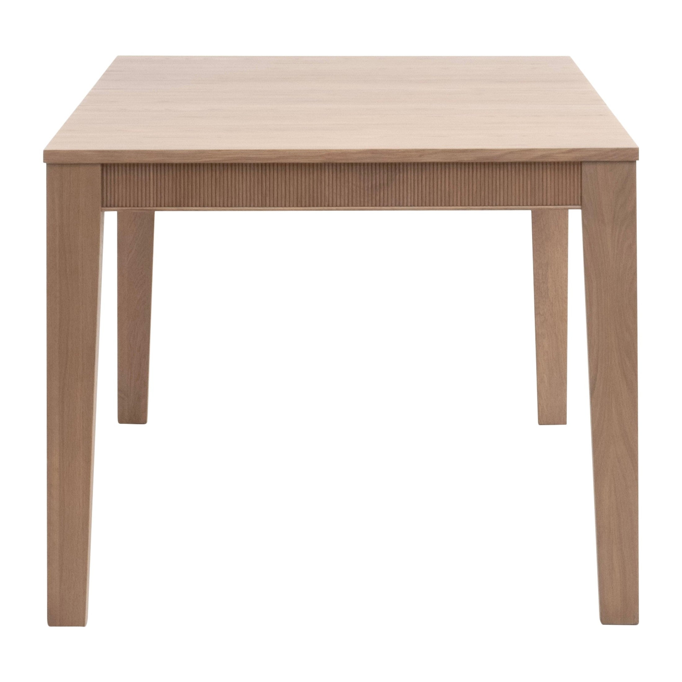 Front view of Highland Extension Dining Table in natural oak with fluted apron, crafted by Essentials for Living.