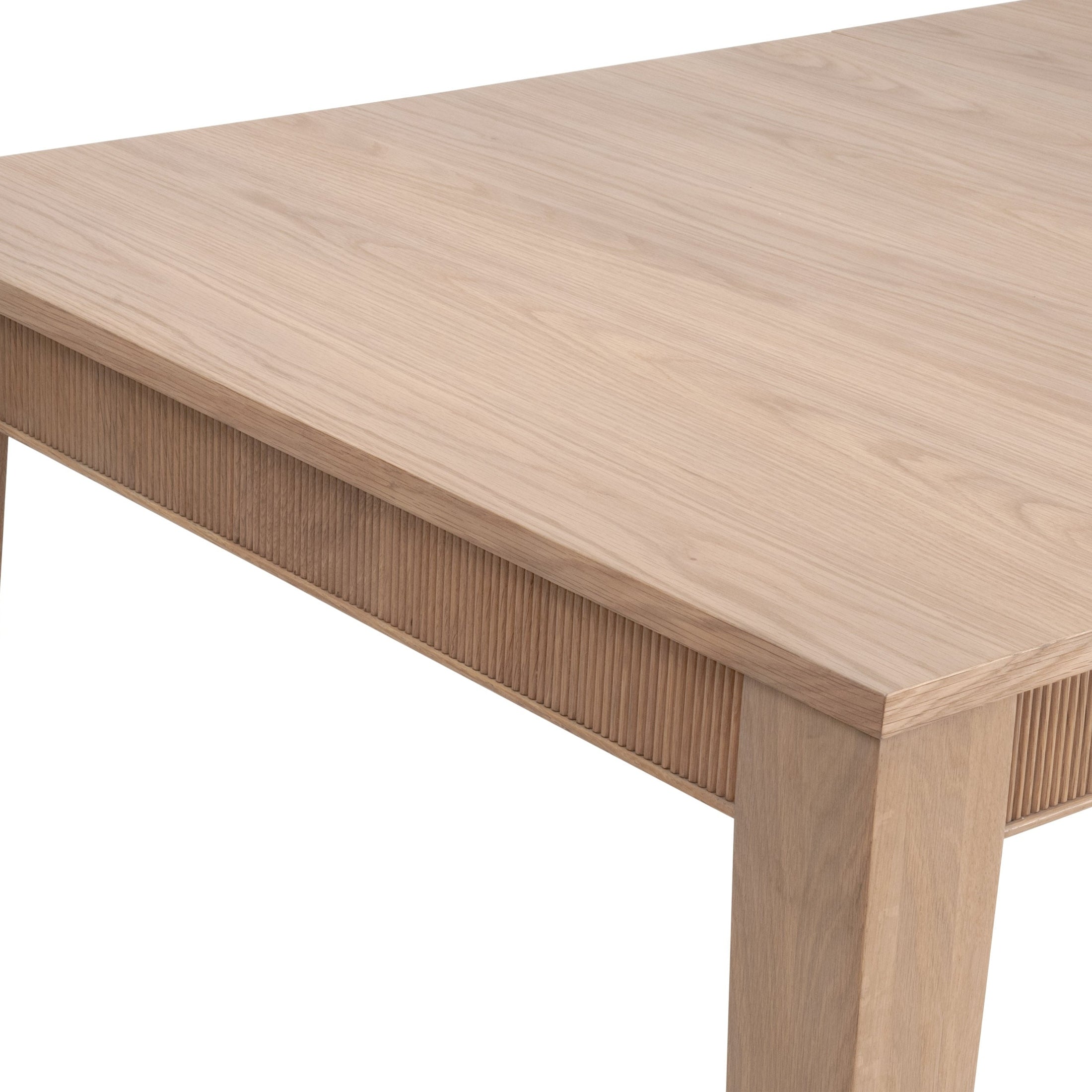 Close-up of Highland Extension Dining Table in natural oak with fluted wood apron by Essentials for Living
