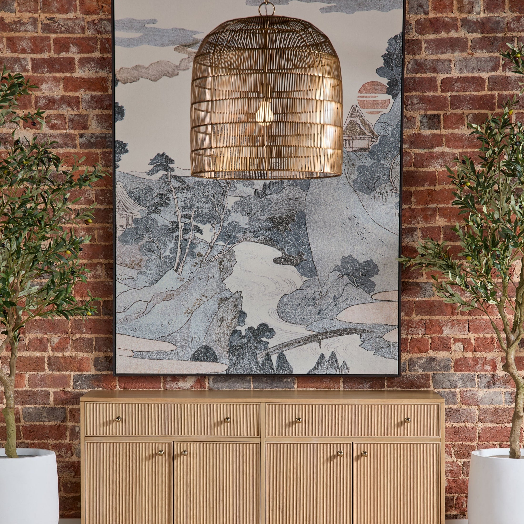 Highland Media Sideboard in natural oak with fluted fronts and brass knobs against exposed brick wall by Essentials For Living