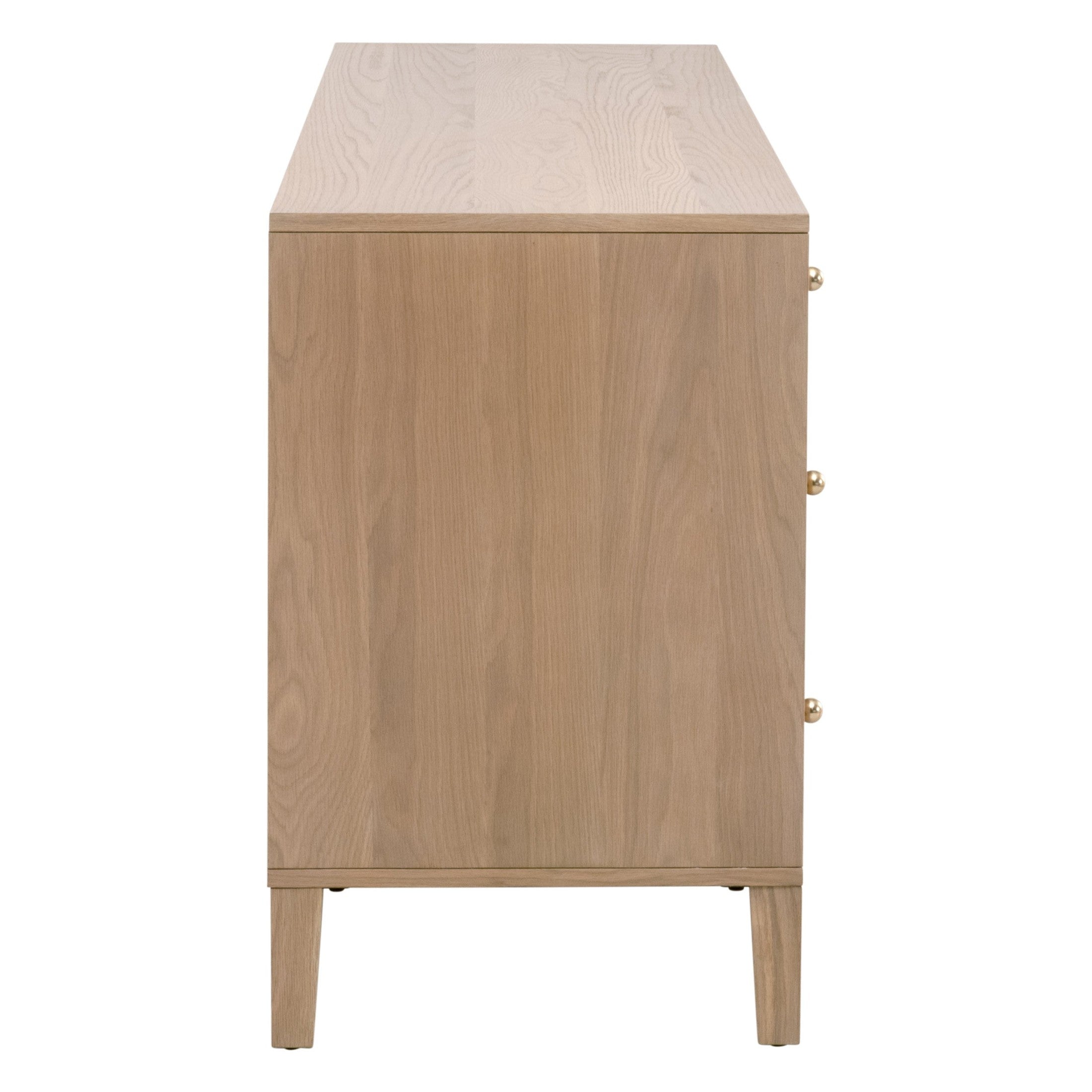 Side view of Essentials For Living Highland 8-Drawer Double Dresser in natural oak finish with polished brass knobs