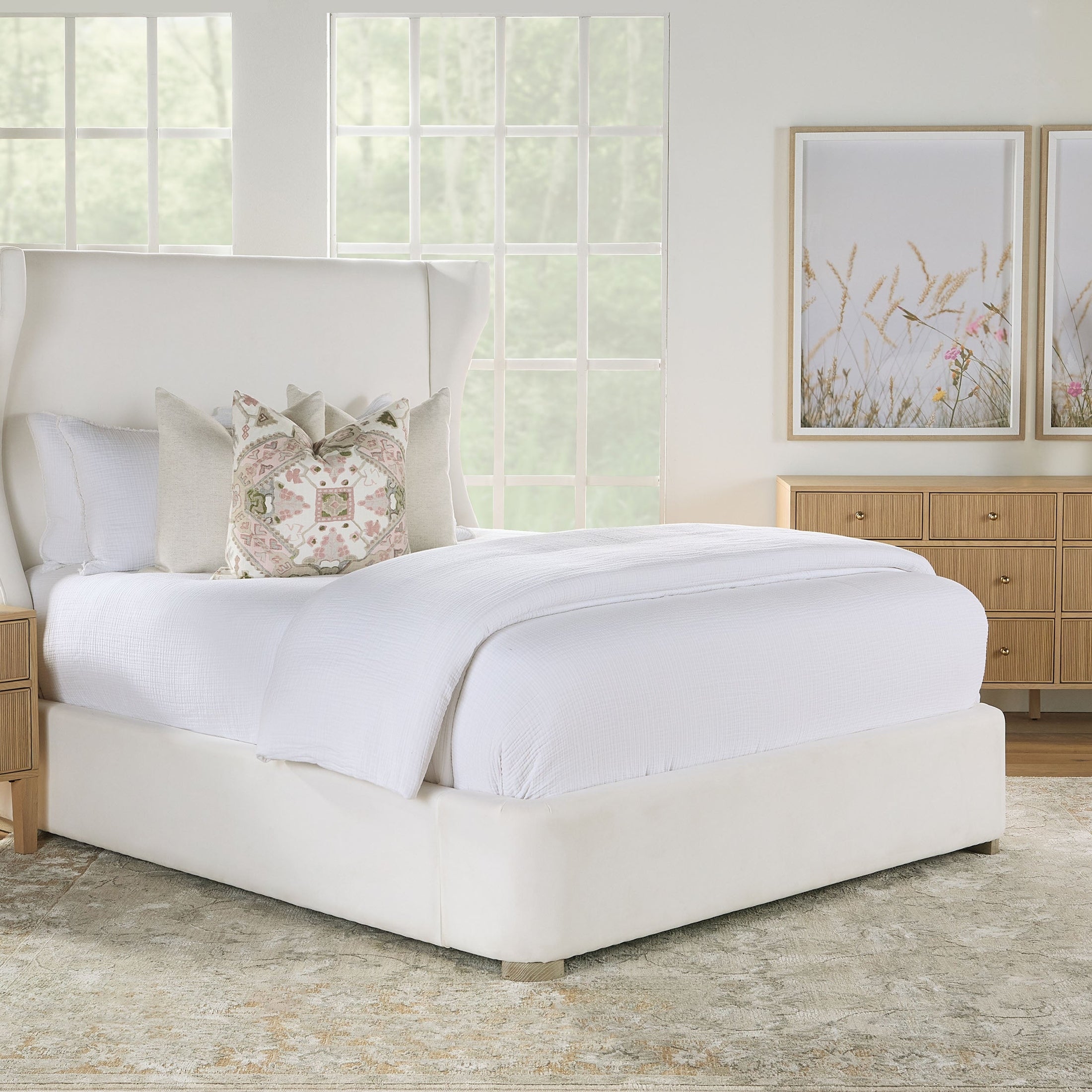 Light oak Highland 8-drawer double dresser with fluted fronts and brass iron knobs in a bright bedroom setting