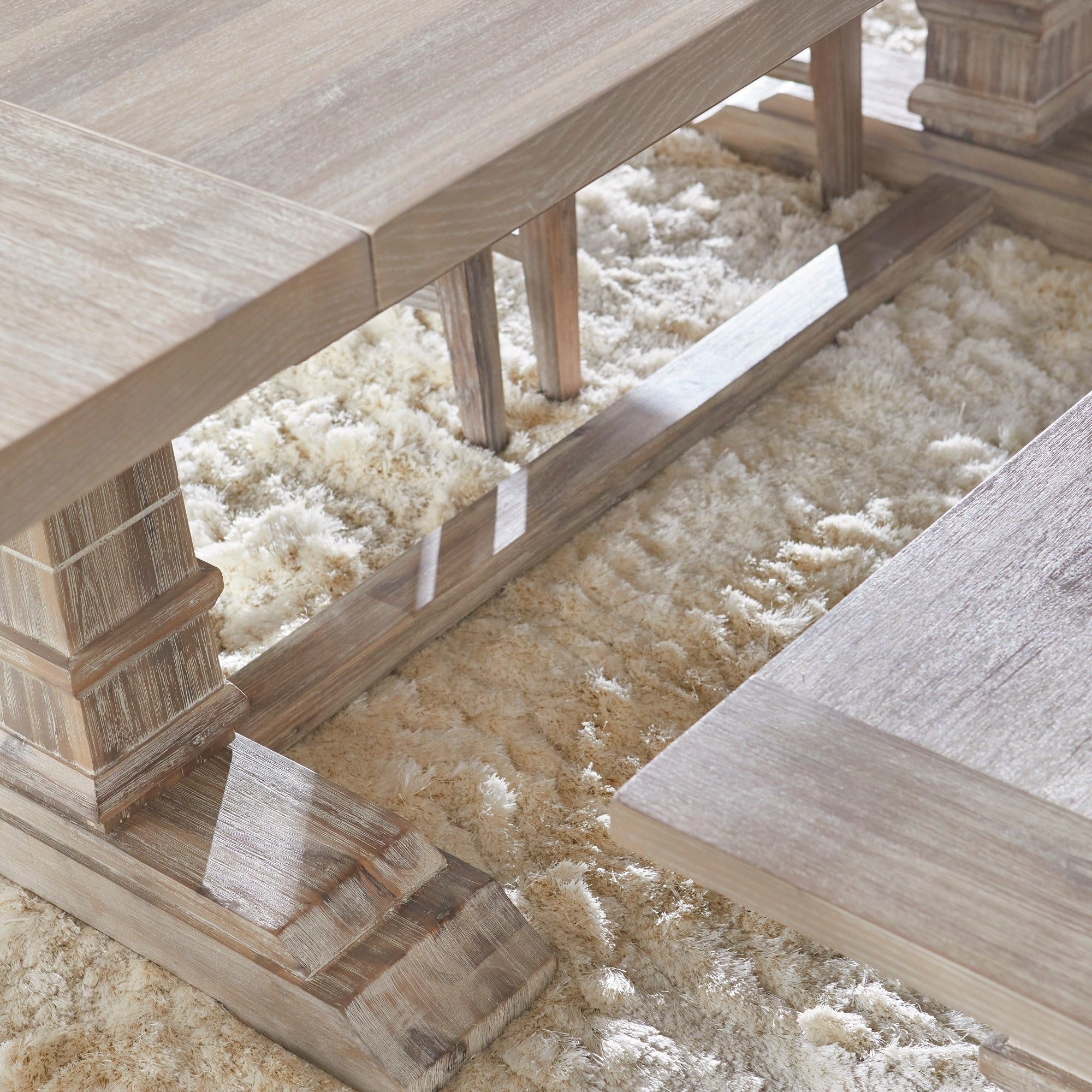 Close-up of Hudson Extension Dining Table in natural gray acacia wood showing trestle base and extension leaf by Essentials for Living