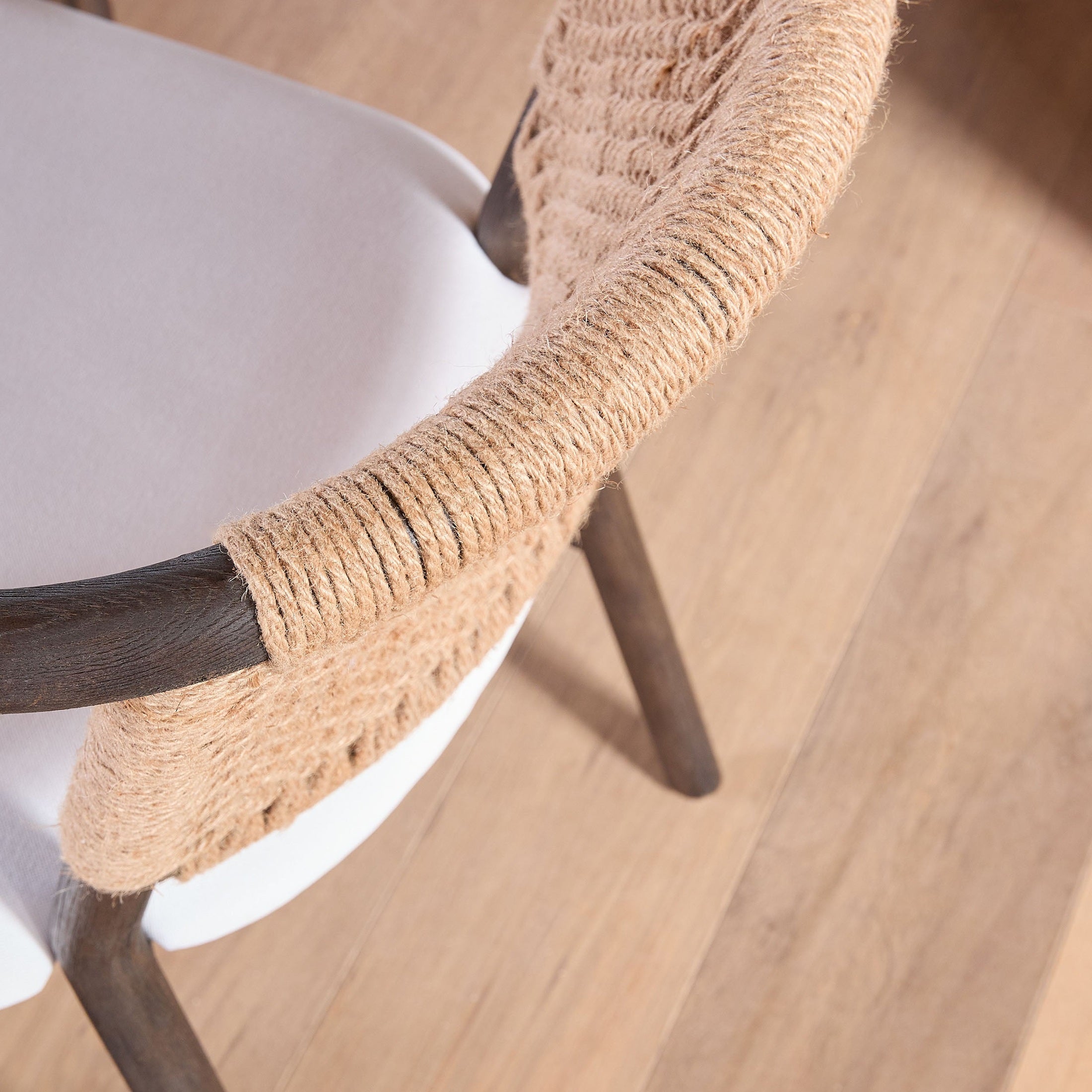 Close-up of Juxtaposition Accent Chair with handwoven jute backrest and white upholstery by Essentials for Living
