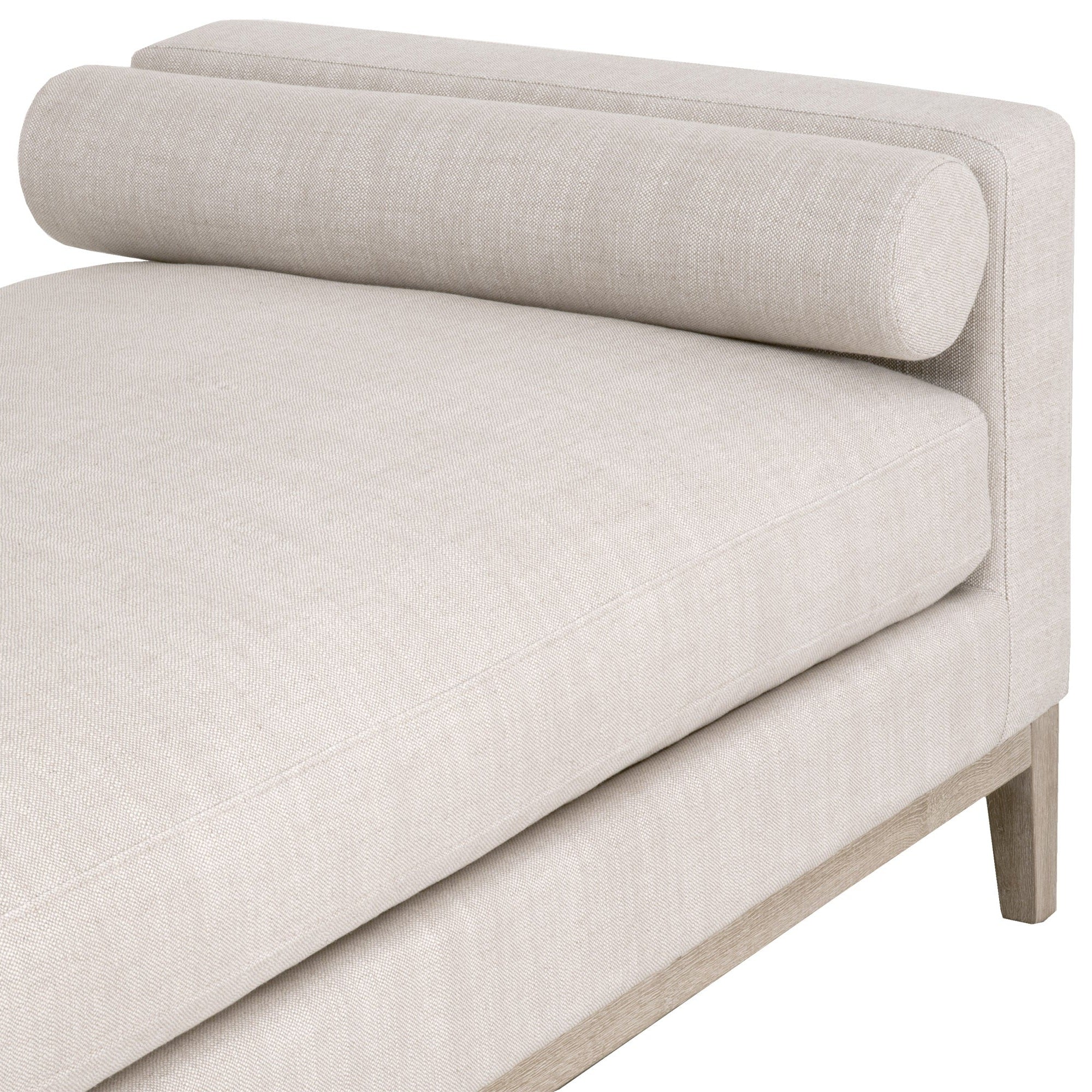 Close-up of Keaton Daybed with bisque upholstery and exposed wood base by Essentials for Living.