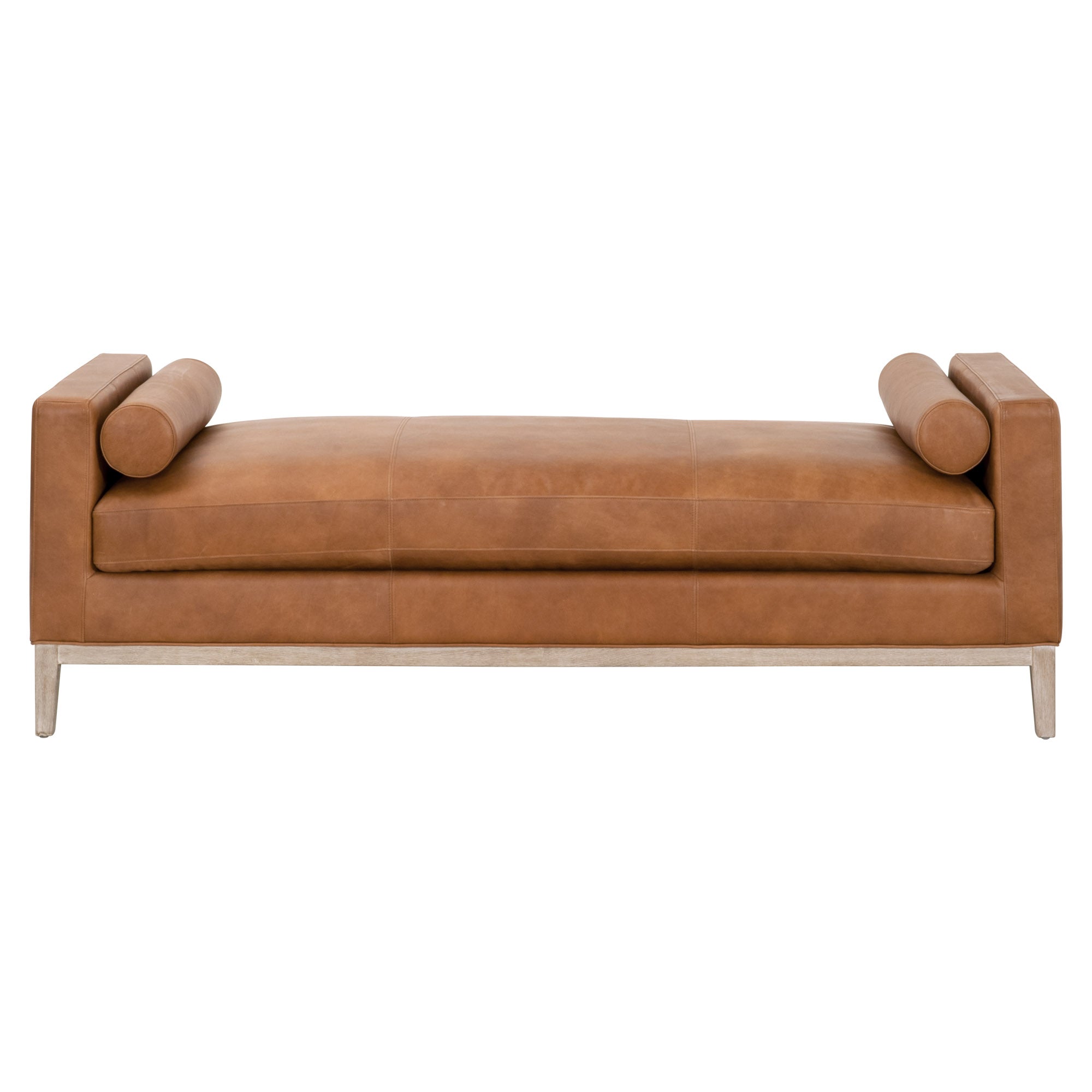 Modern brown leather daybed with cylindrical bolster pillows and exposed wood base in a minimalist style