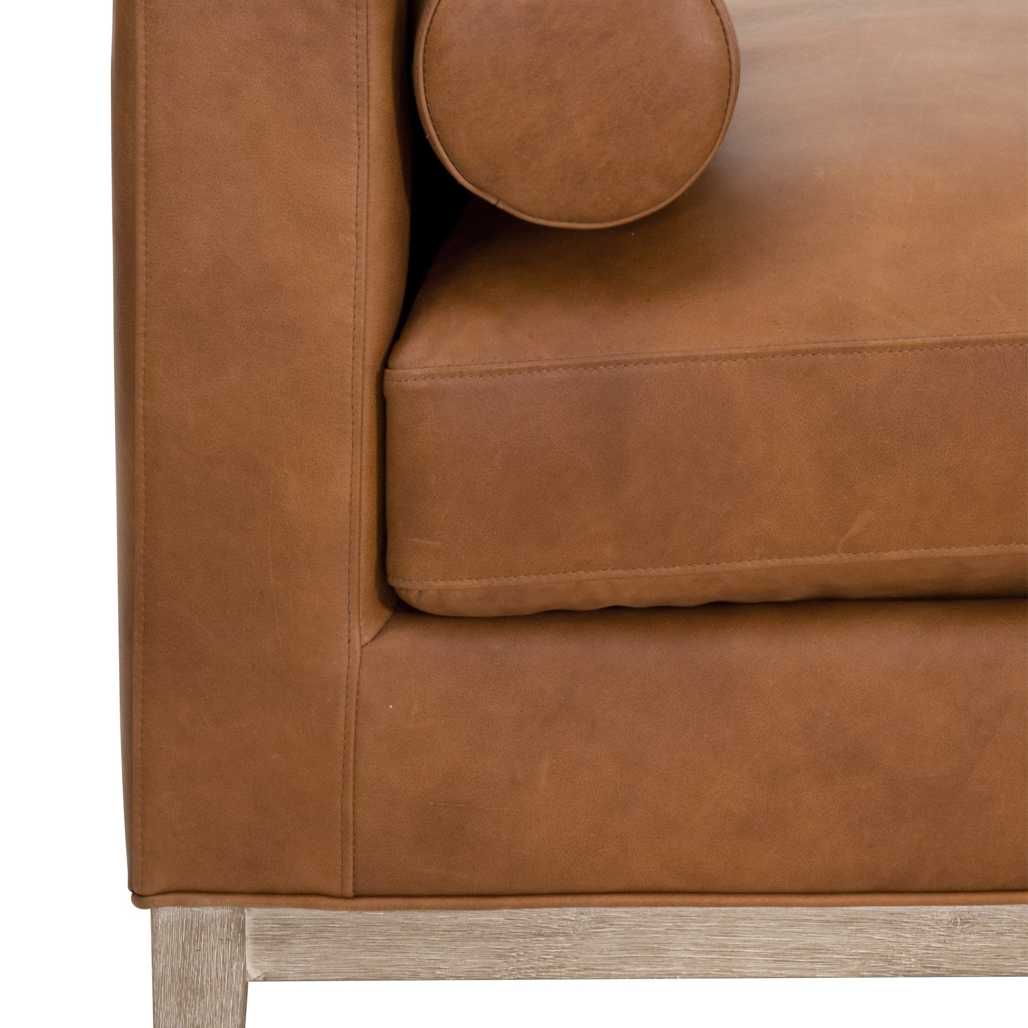 Close-up of Keaton Daybed corner showing tan upholstery and light wood base by Essentials for Living