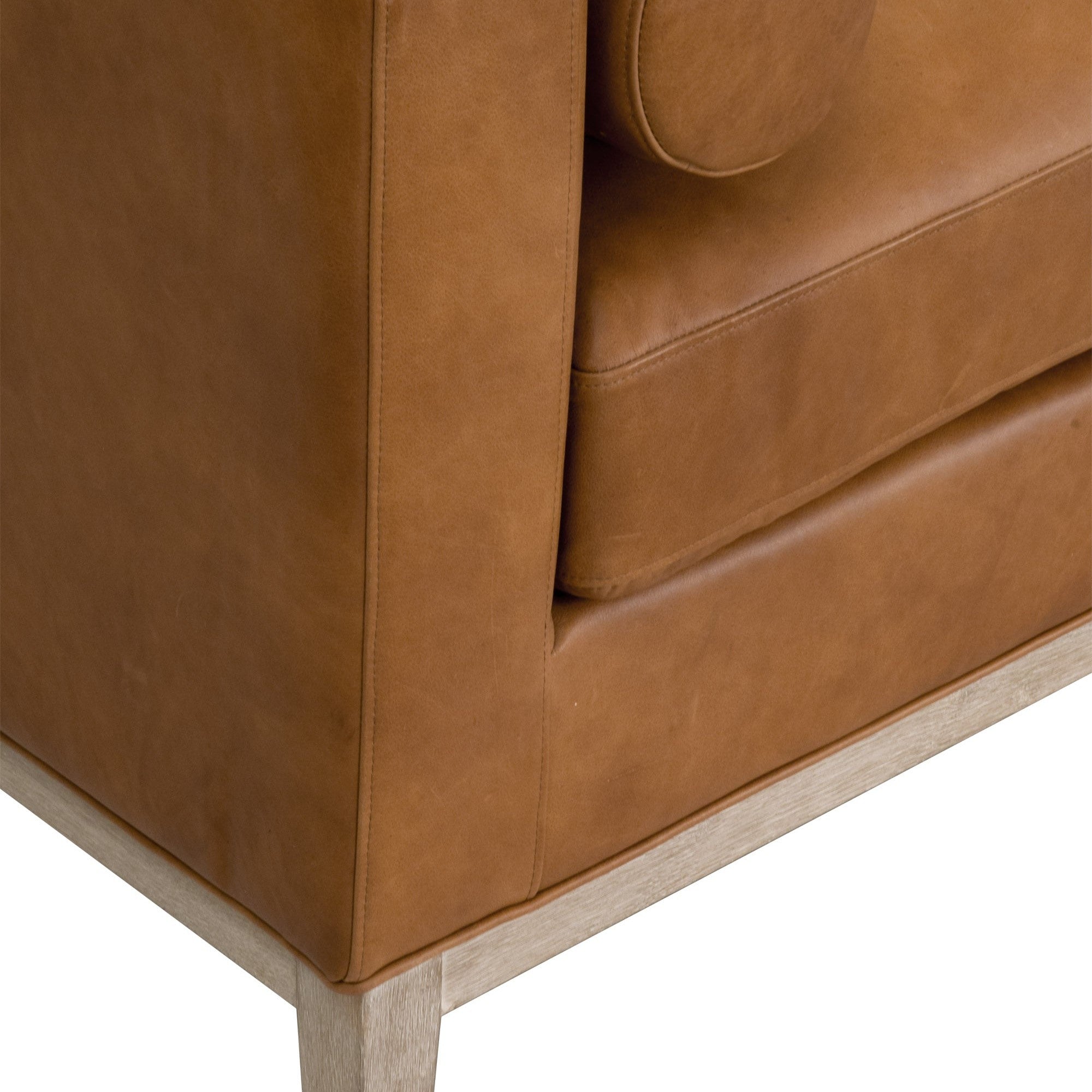 Close-up of brown leather upholstery and exposed wood base detail on Essentials For Living Keaton Daybed.