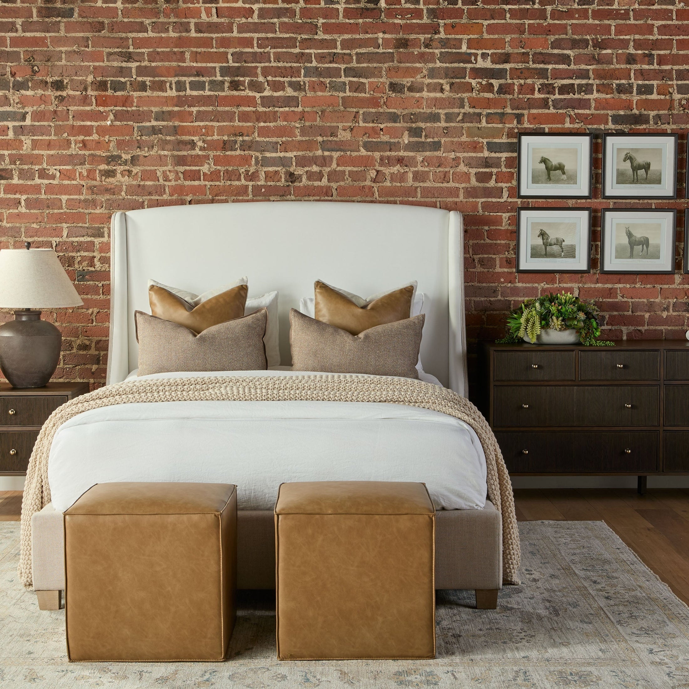 Two Knox Accent Cubes in live smart Walden-Stone fabric placed at the foot of a bed in a stylish bedroom.