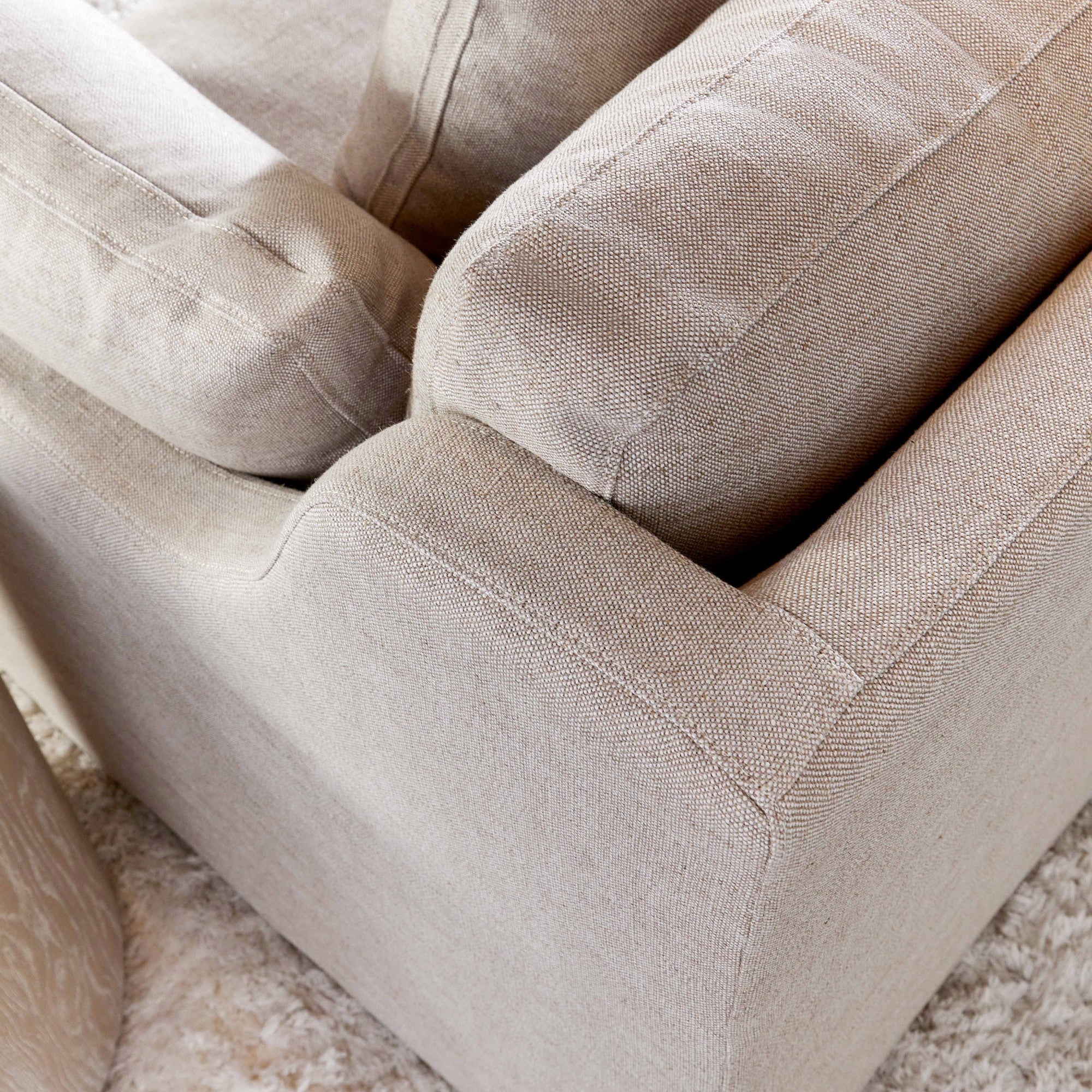 Close-up of light beige linen-blend upholstery on Lena 95" Slope Arm Slipcover Sofa by Essentials for Living