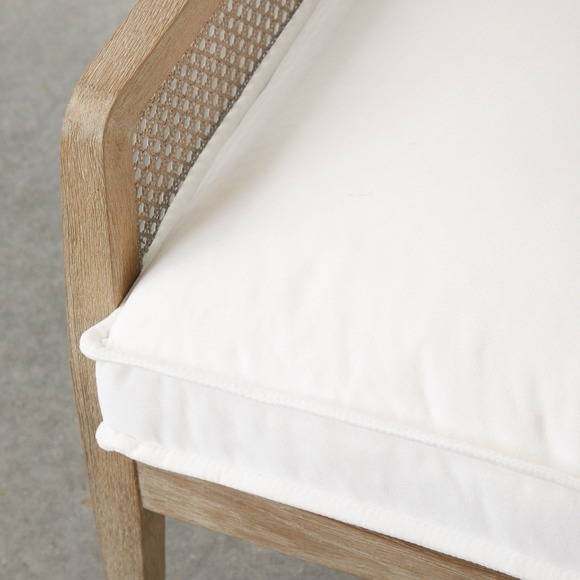Close-up of Leone Club Chair corner with natural gray oak frame and white removable cushion by Essentials For Living