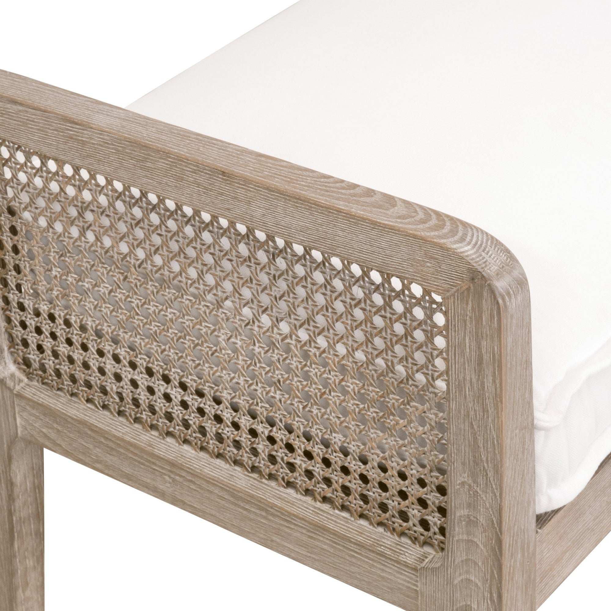Close-up of Leone Bench corner showing natural gray oak frame and intricate cane inlay with white cushion from Essentials For Living