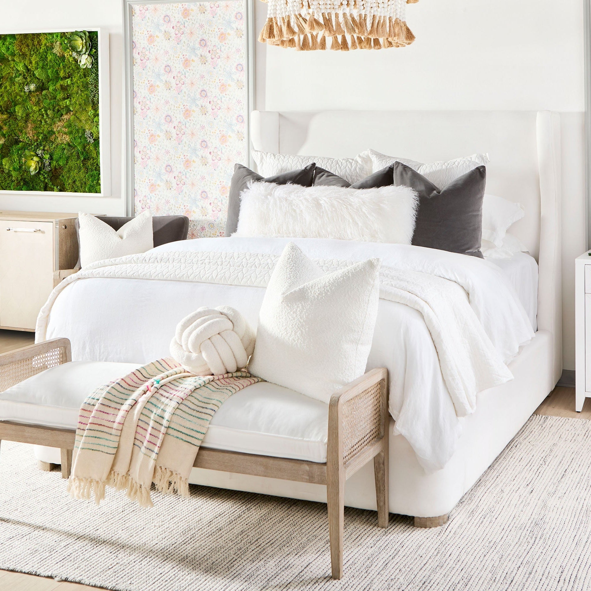 Leone Bench with natural gray oak frame and white cushion at foot of bed in bright, airy bedroom setting.