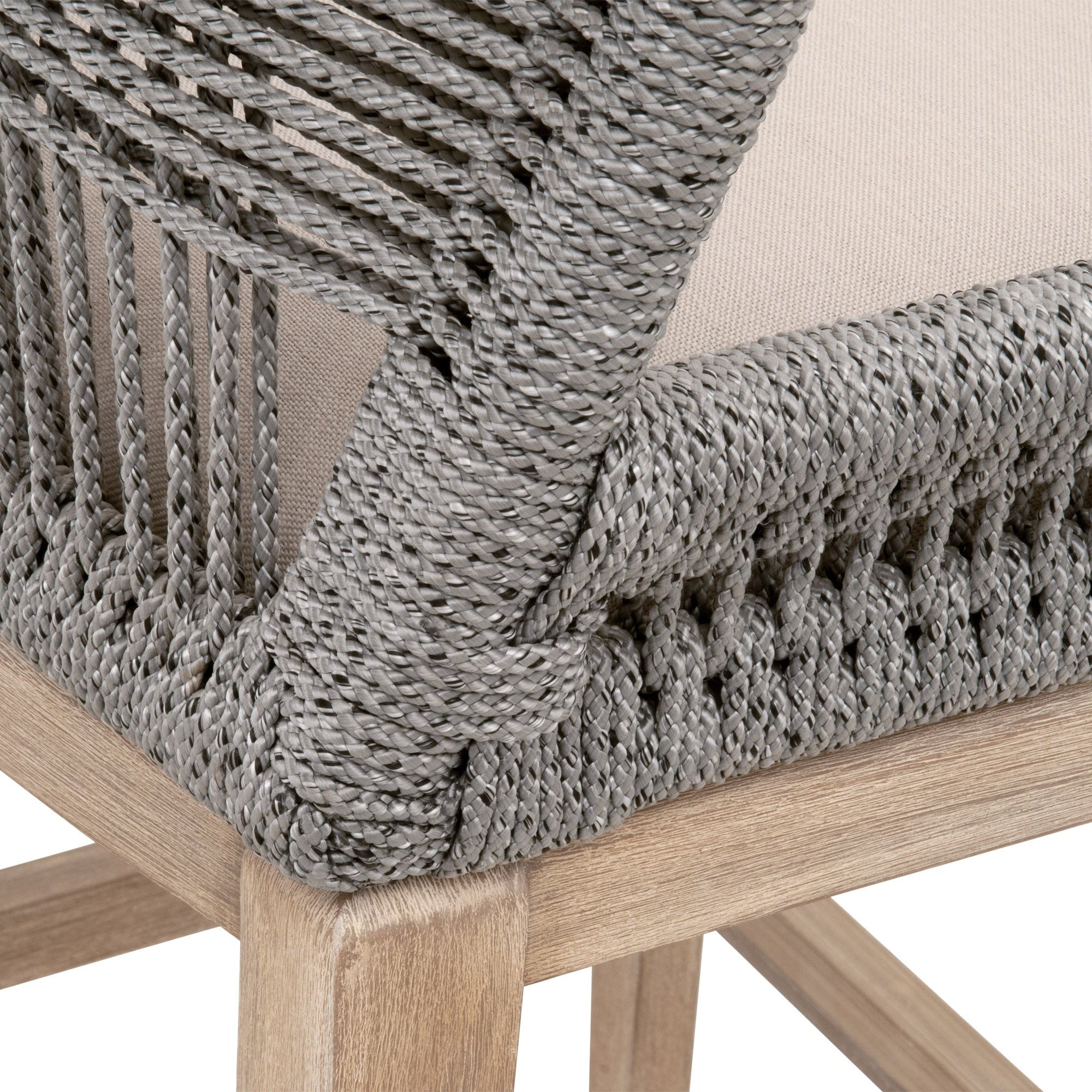 Close-up of the woven taupe rope backrest and pumice fabric seat on a distressed gray wood Loom Barstool leg