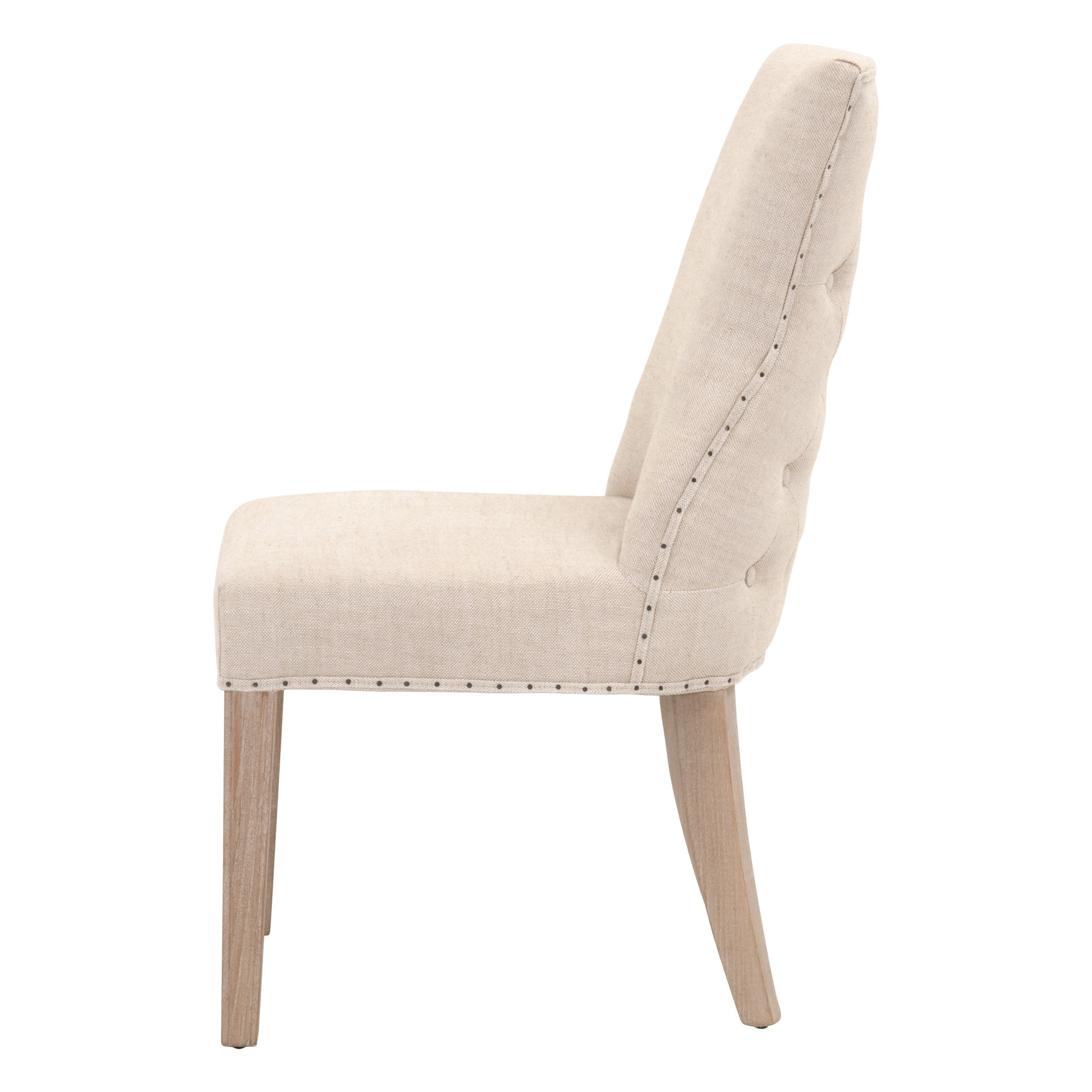 Side view of Lourdes Dining Chair in bisque linen with tufted back and gray ash wood legs, Essentials for Living