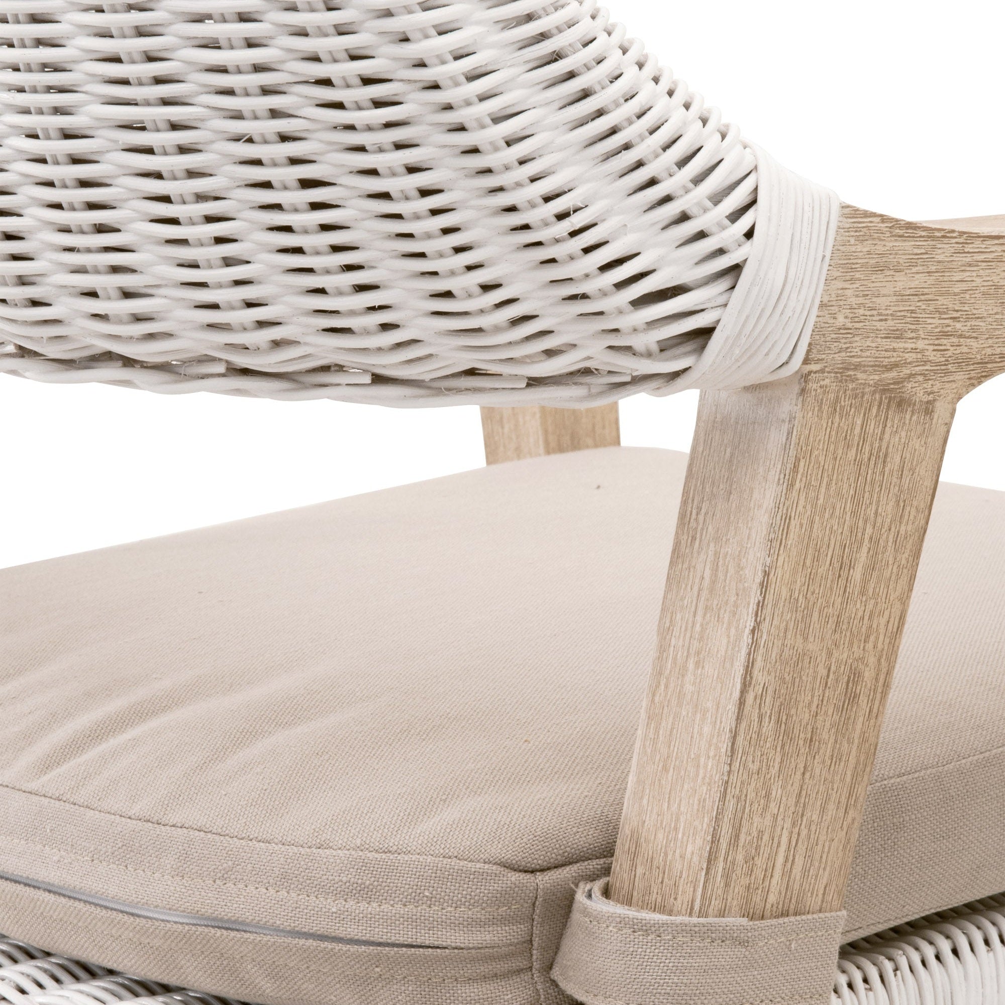 Close-up of white rattan wicker arm and light gray cushion on Lucia Arm Chair by Essentials for Living