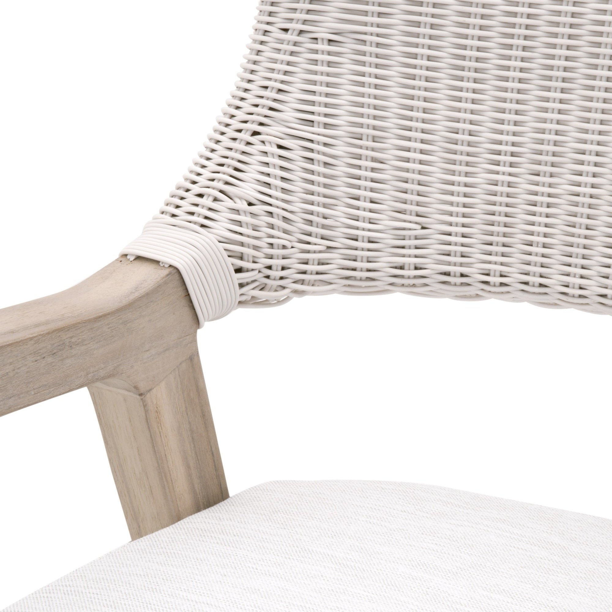 Close-up of Lucia Outdoor Arm Chair showing white wicker backrest and gray teak wood frame by Essentials for Living