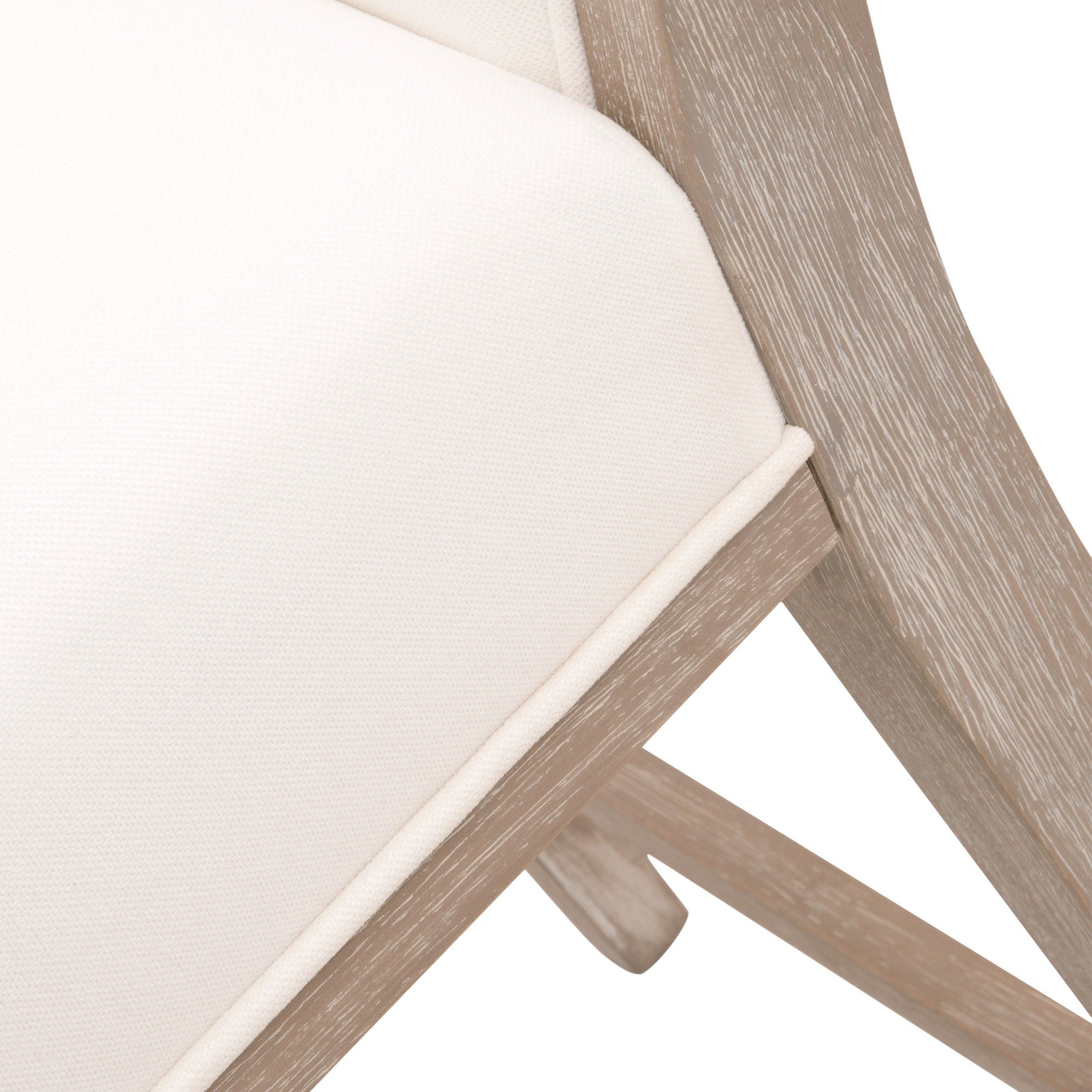 Close-up of a light fabric upholstered seat with natural gray solid wood frame and leg stretchers on a counter stool.