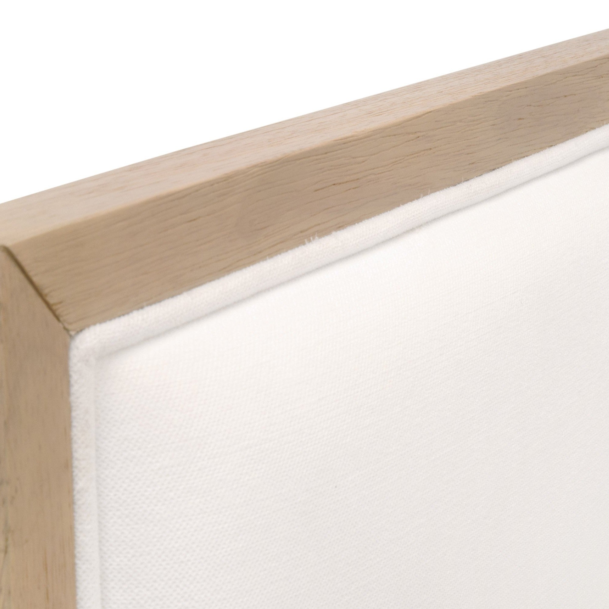 Close-up of natural gray solid rubberwood frame and white upholstery fabric edge on dining chair backrest