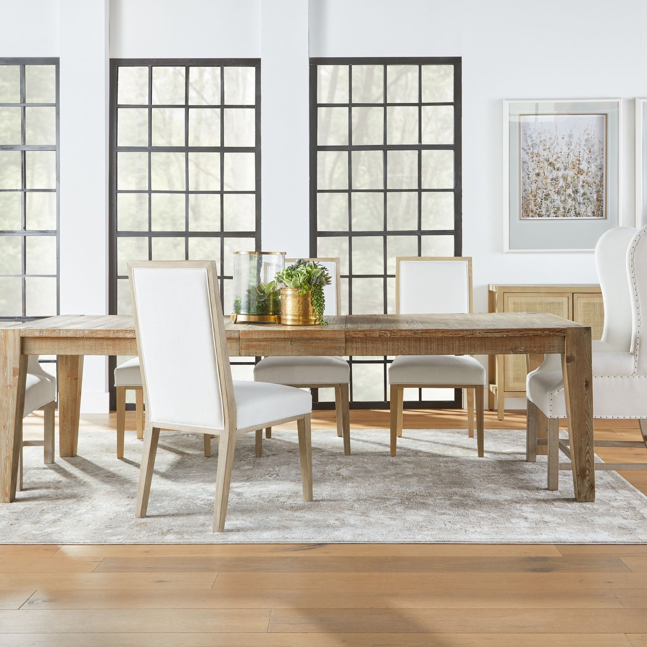 Set of two Essentials for Living Martin Dining Chairs with light upholstery and natural wood frames in a bright dining room.