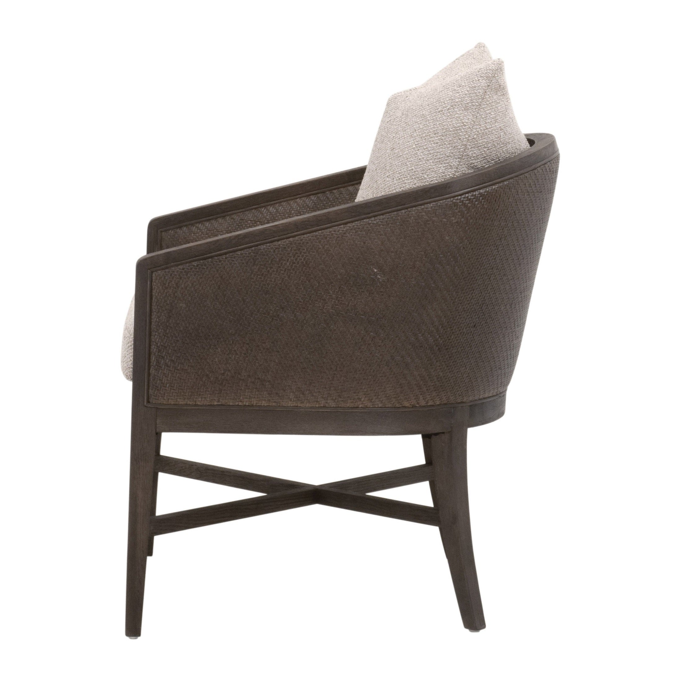 Side view of McGuire Arm Chair by Essentials for Living with dark rattan frame and light cushion and pillow