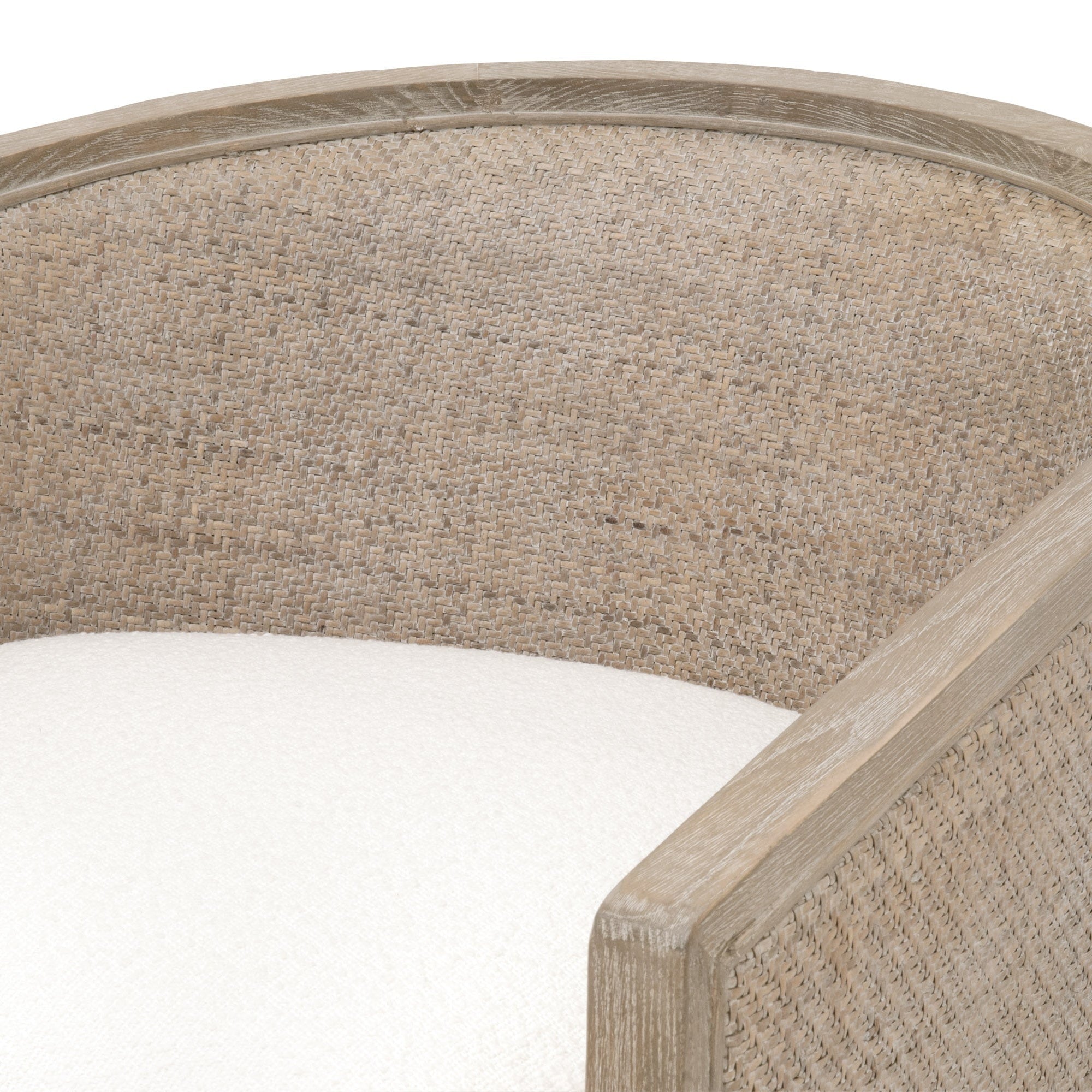 Close-up of McGuire swivel club chair with handwoven natural gray cane and white boucle upholstery by Essentials For Living