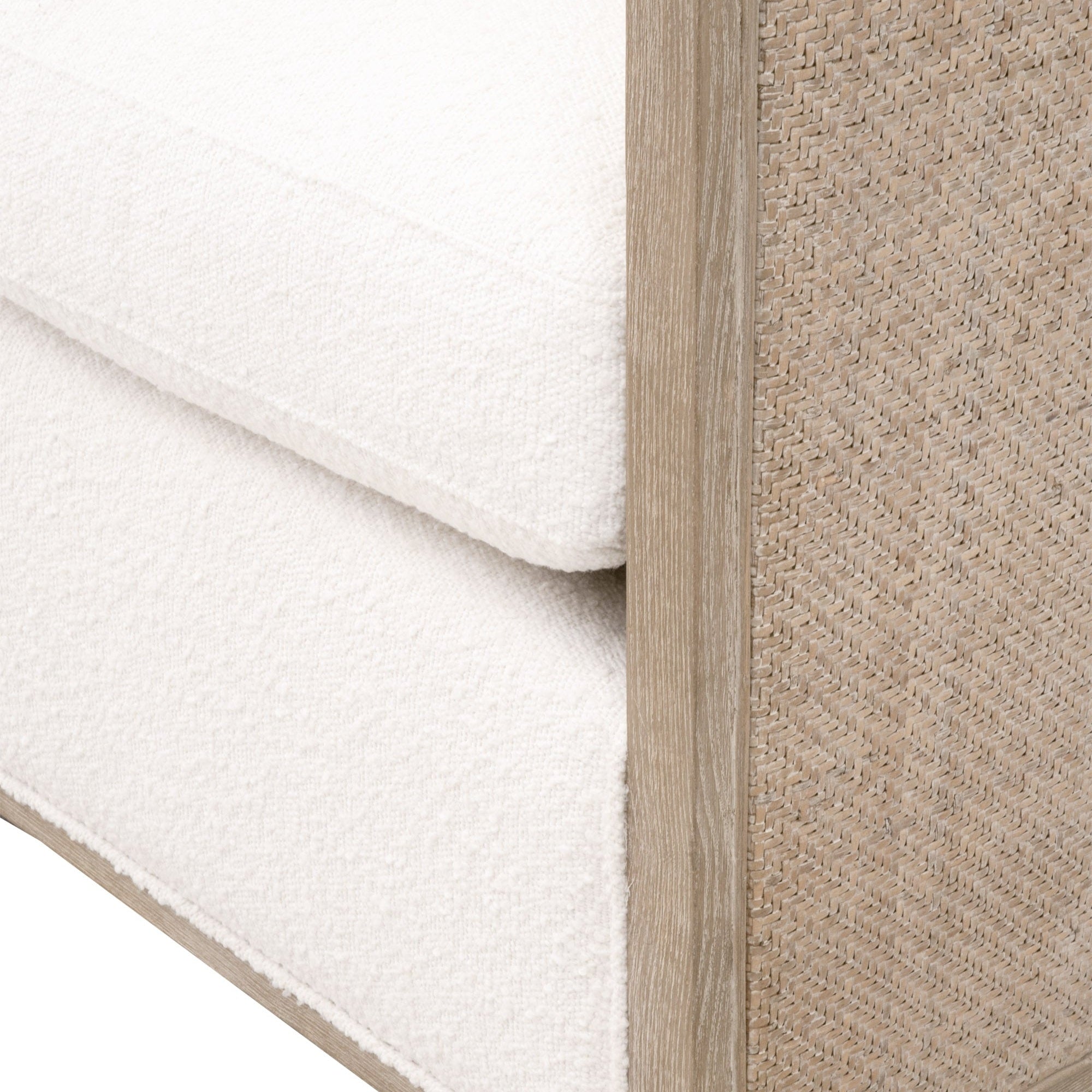 Close-up of McGuire Swivel Club Chair showing handwoven natural gray cane, solid oak frame, and soft snow boucle upholstery.