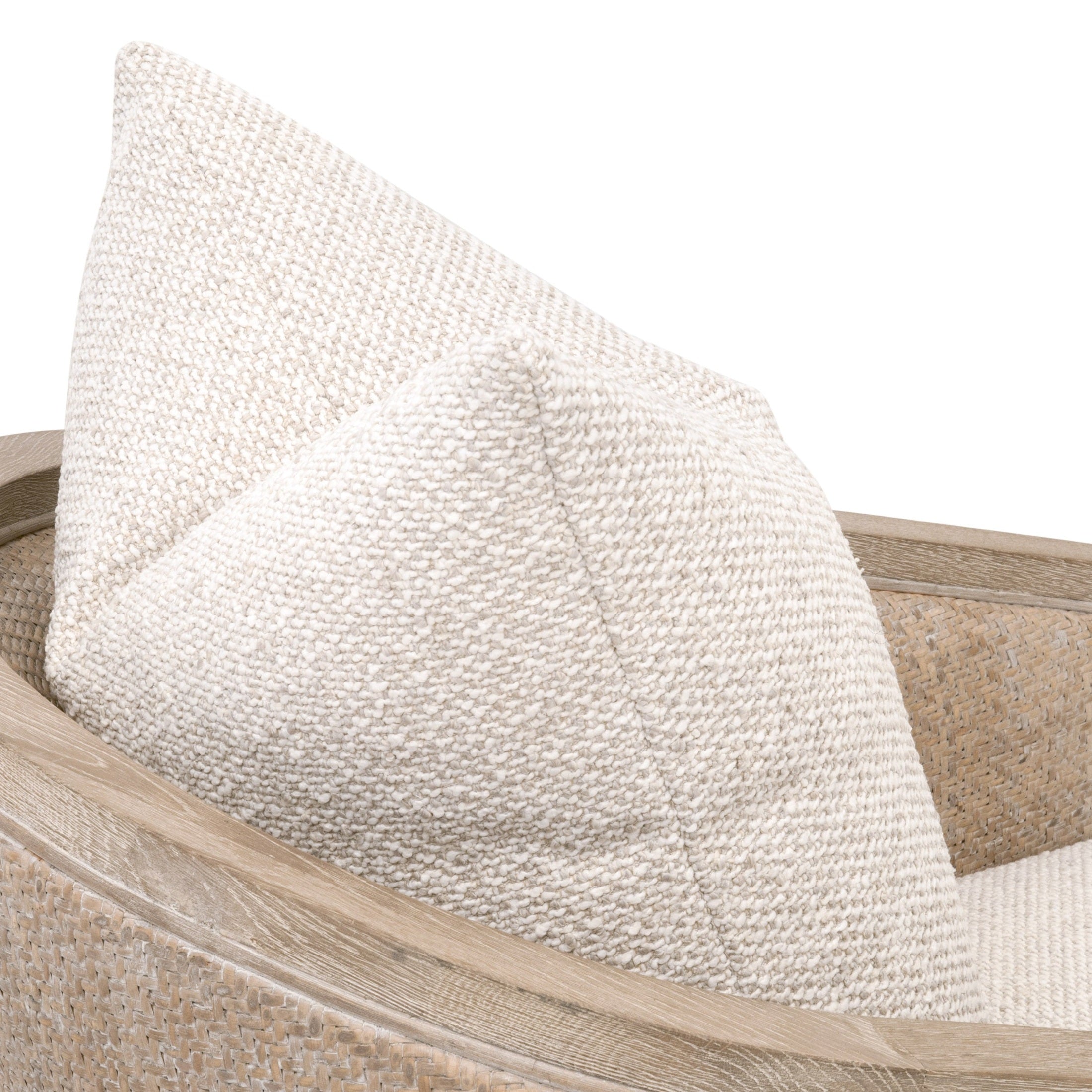 Close-up of Essentials for Living McGuire Arm Chair showing textured natural gray rattan frame and neutral fabric pillow.