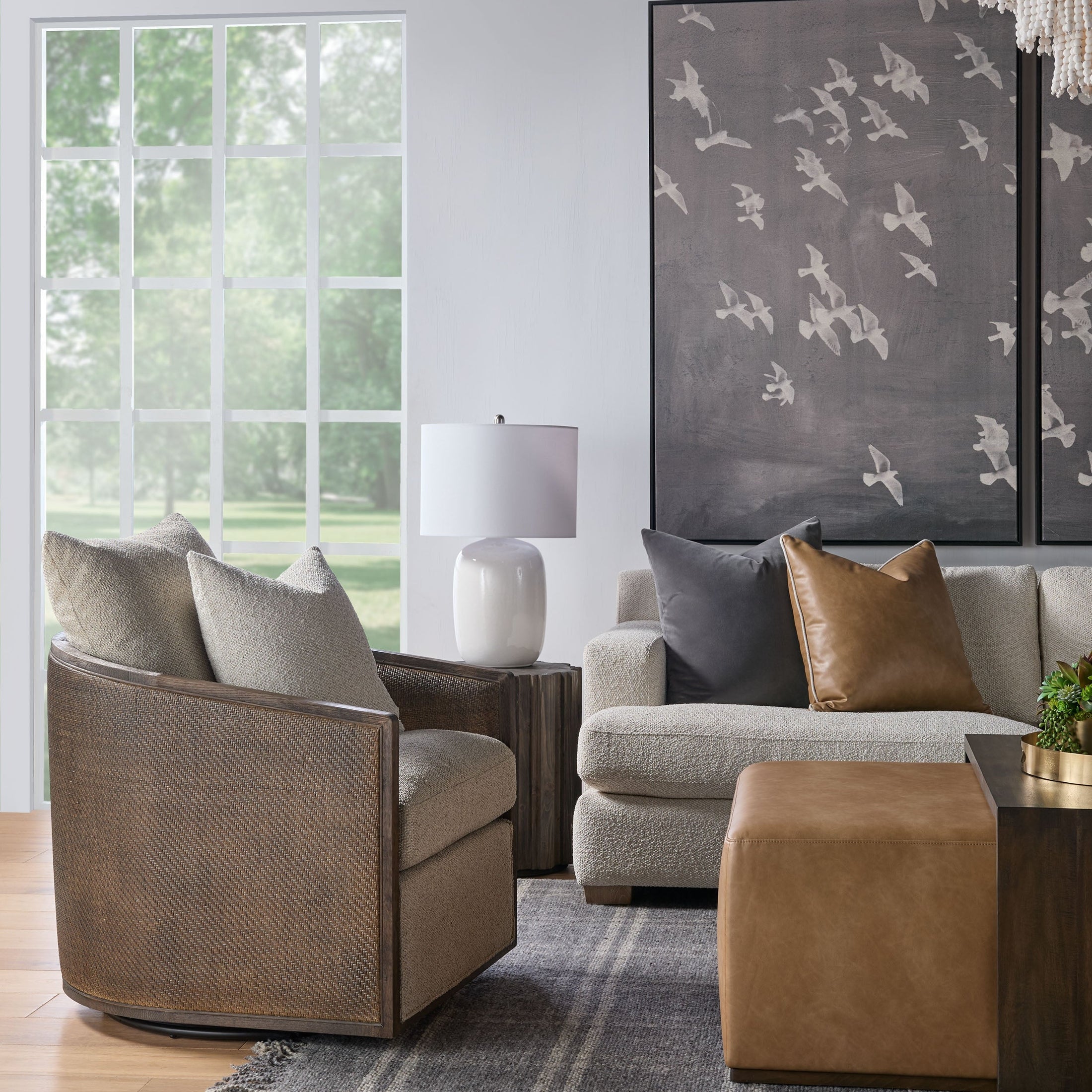 Essentials For Living swivel club chair with handwoven cane frame and plush boucle upholstery in a modern living room setting