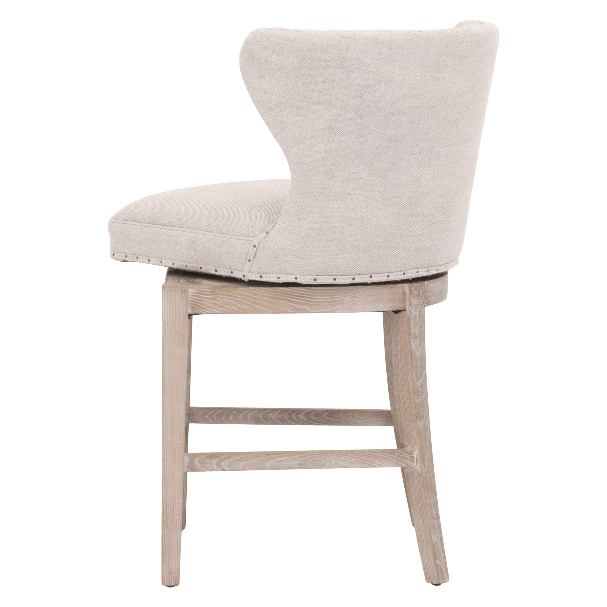 Milton swivel counter stool with Bisque French Linen upholstery, black nail-tack trim, and natural gray ash-wood frame