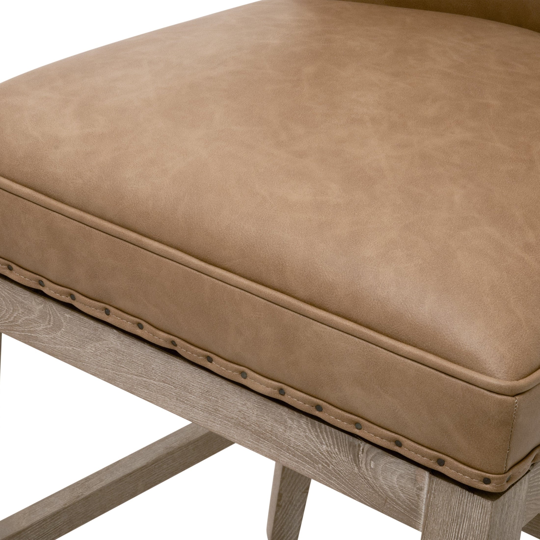Close-up of Essentials for Living Milton Swivel Counter Stool seat with bisque upholstery and black nail-tack trim detail