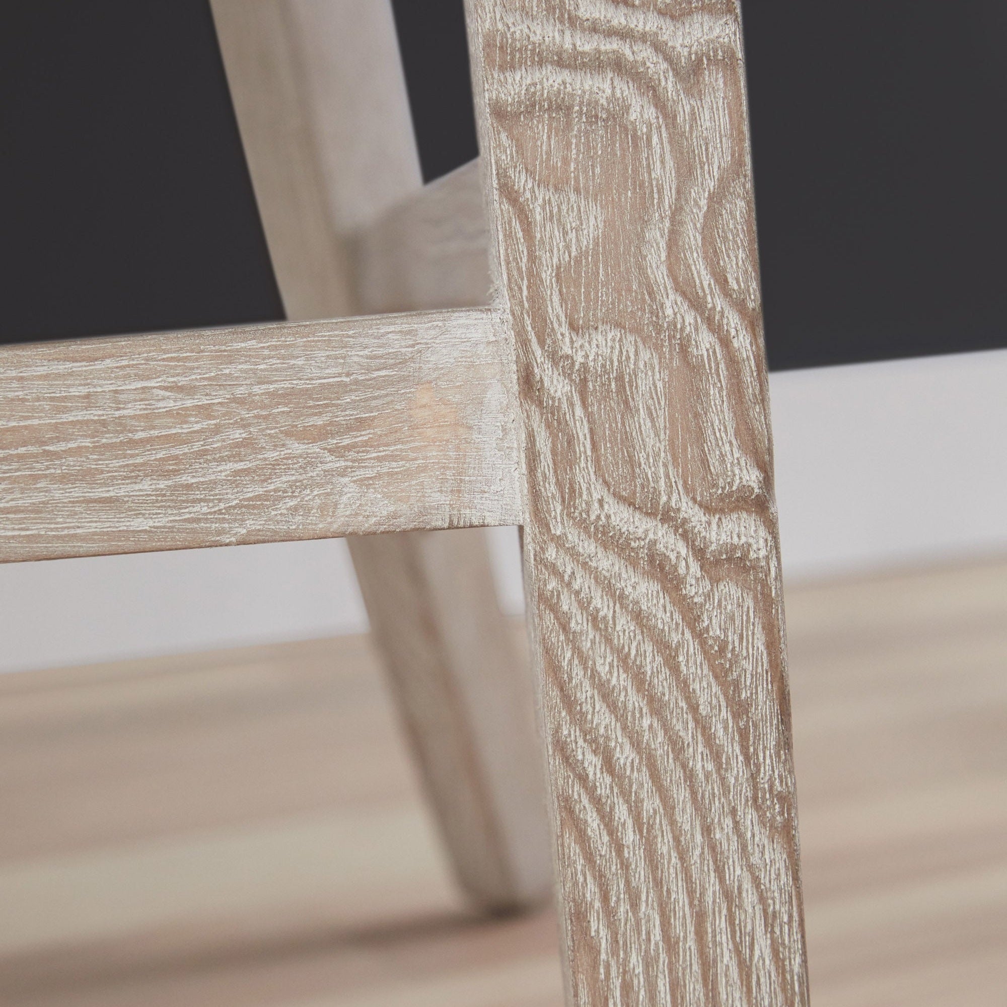 Close-up of natural gray ash-wood frame with visible grain on the Milton Swivel Counter Stool by Essentials For Living