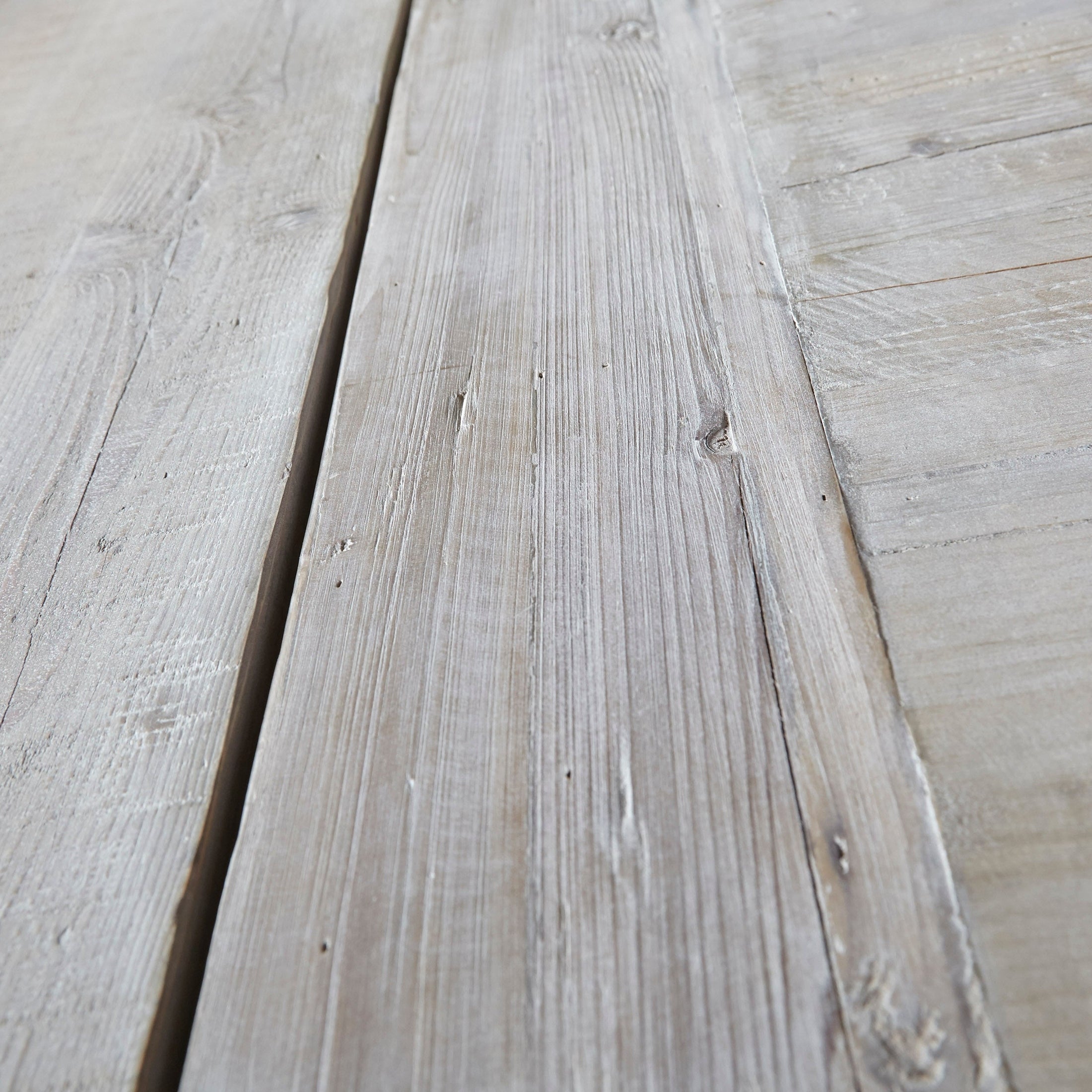Close-up of the reclaimed smoke gray pine wood grain on the Monastery Extension Dining Table by Essentials for Living