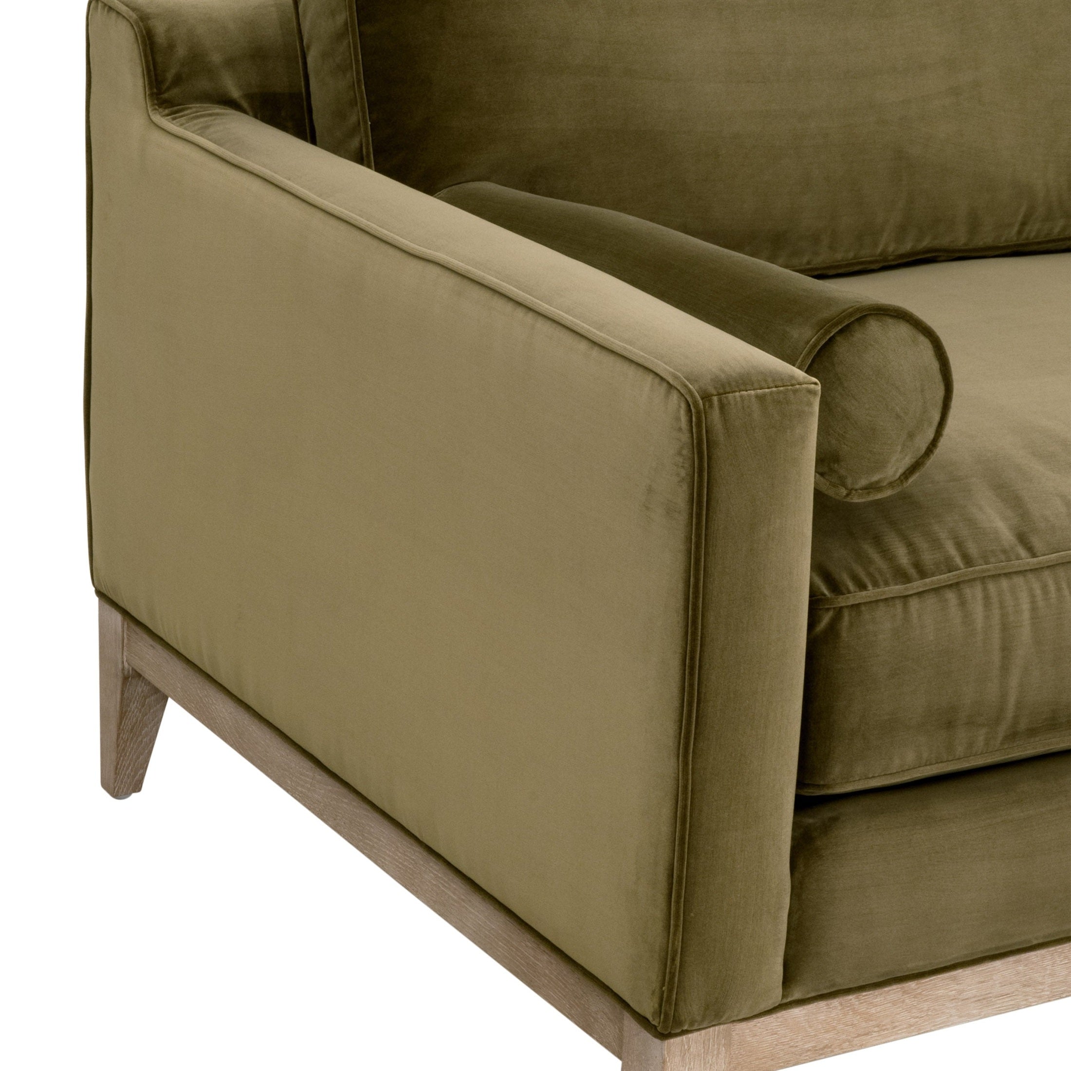 Close-up of Essentials for Living Parker 86" sofa arm in olive green velvet with natural gray oak base and bolster pillow