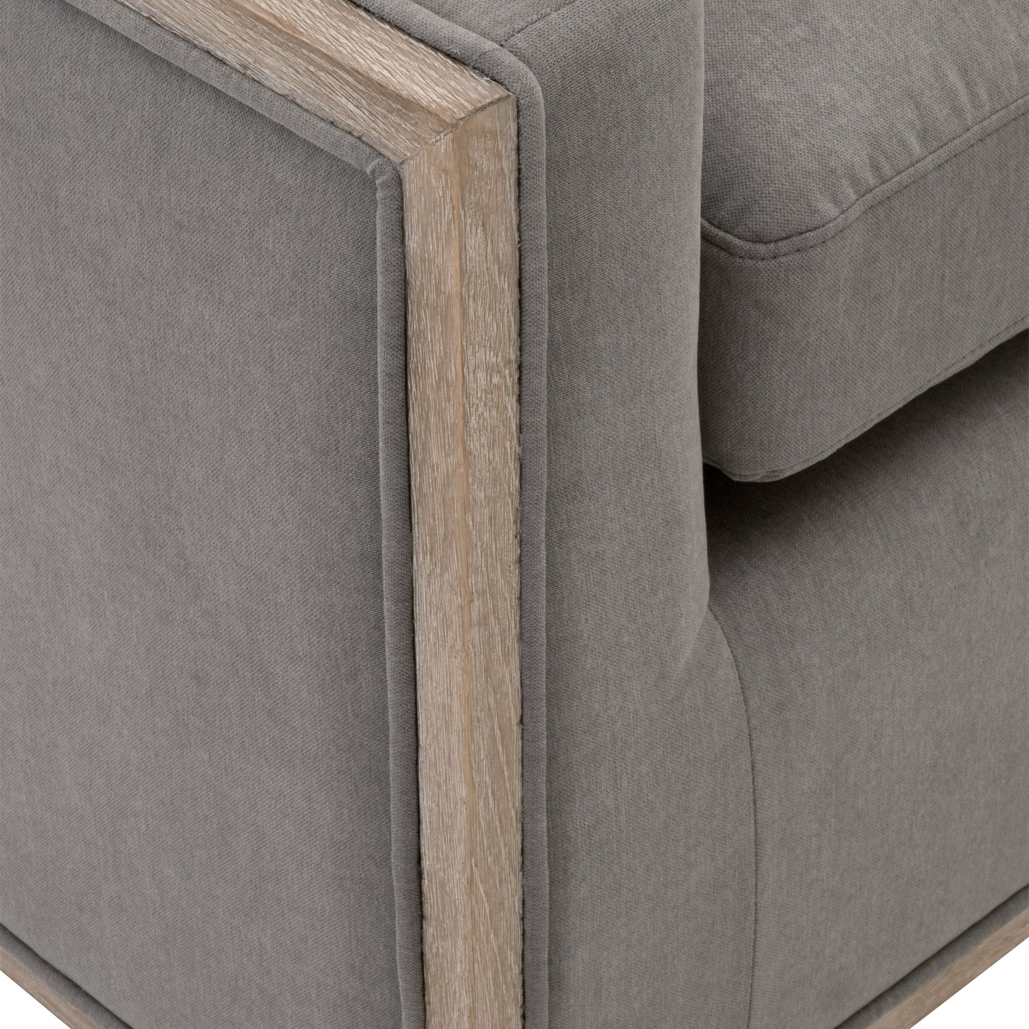 Close-up of gray upholstered Paxton Swivel Club Chair with natural gray solid oak trim by Essentials For Living