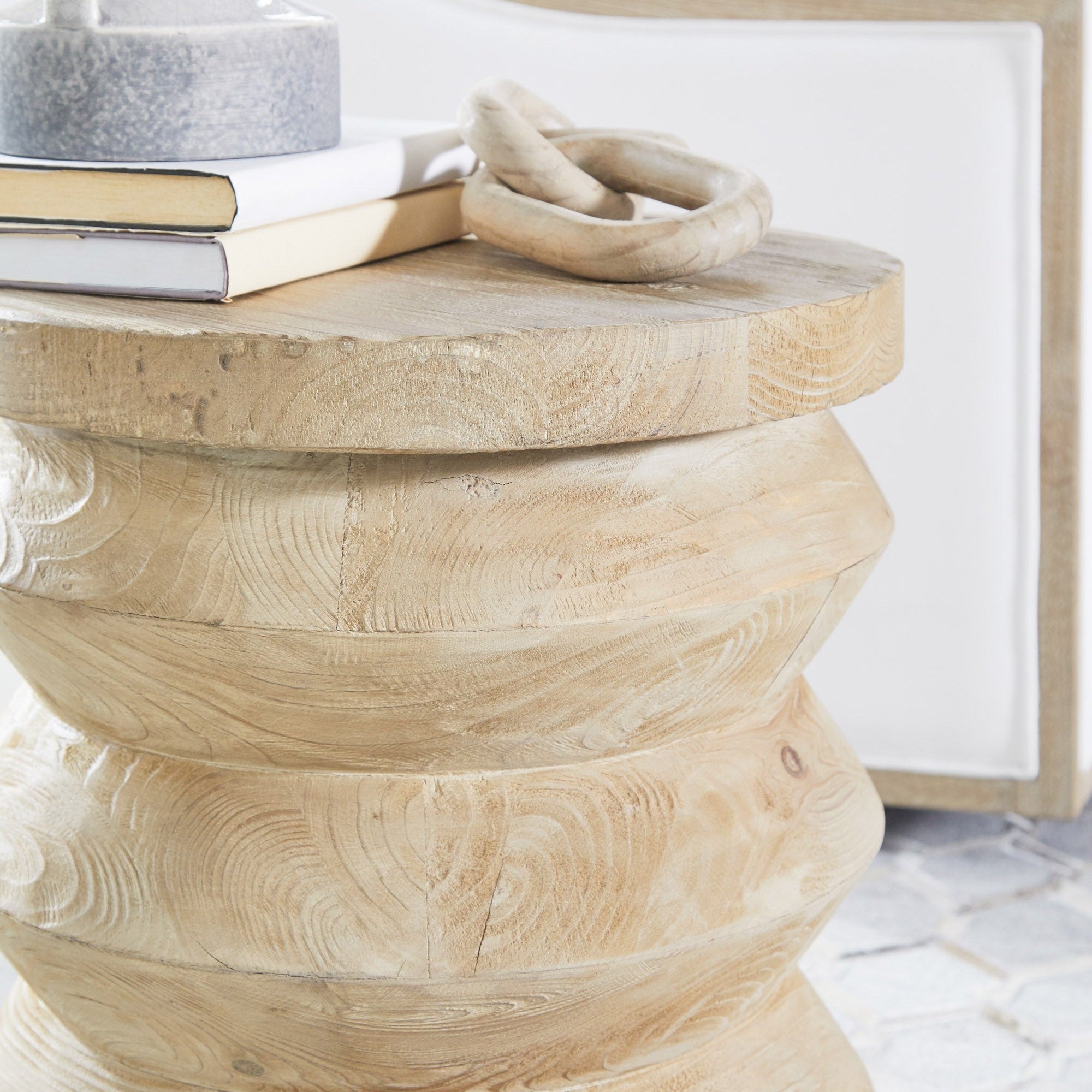 Close-up of a natural reclaimed pine Pier Accent Table by Essentials For Living with decorative items on top