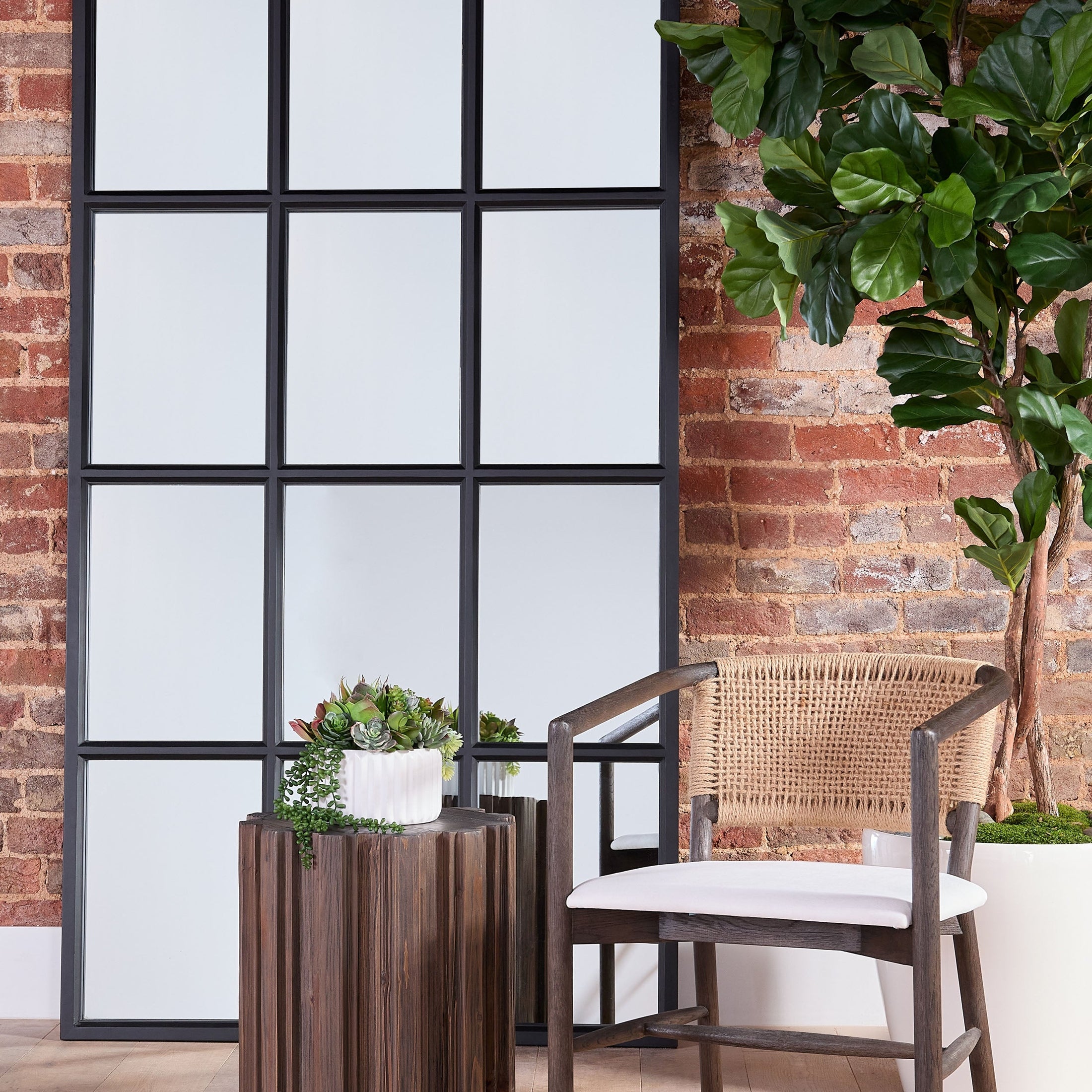 Roma Accent Table by Essentials For Living with fluted pedestal and drift brown reclaimed pine finish in cozy room setting