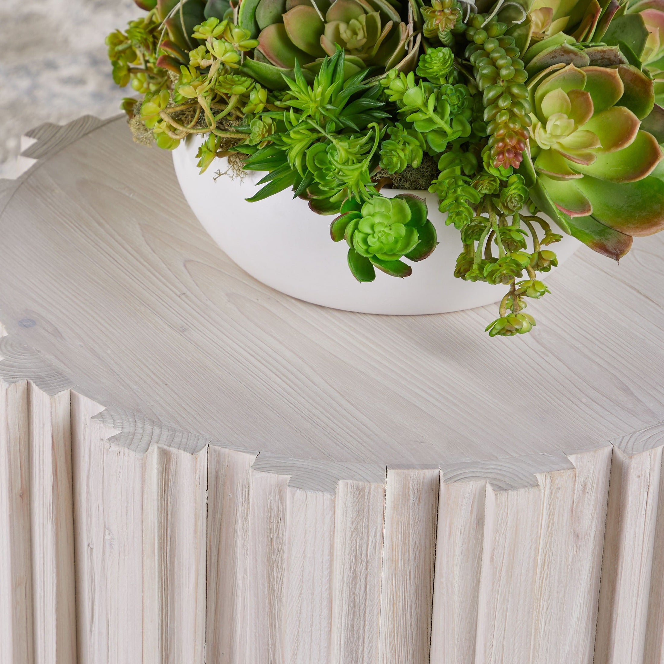 Close-up of Essentials For Living Roma Accent Table top with fluted pedestal and succulent plant arrangement