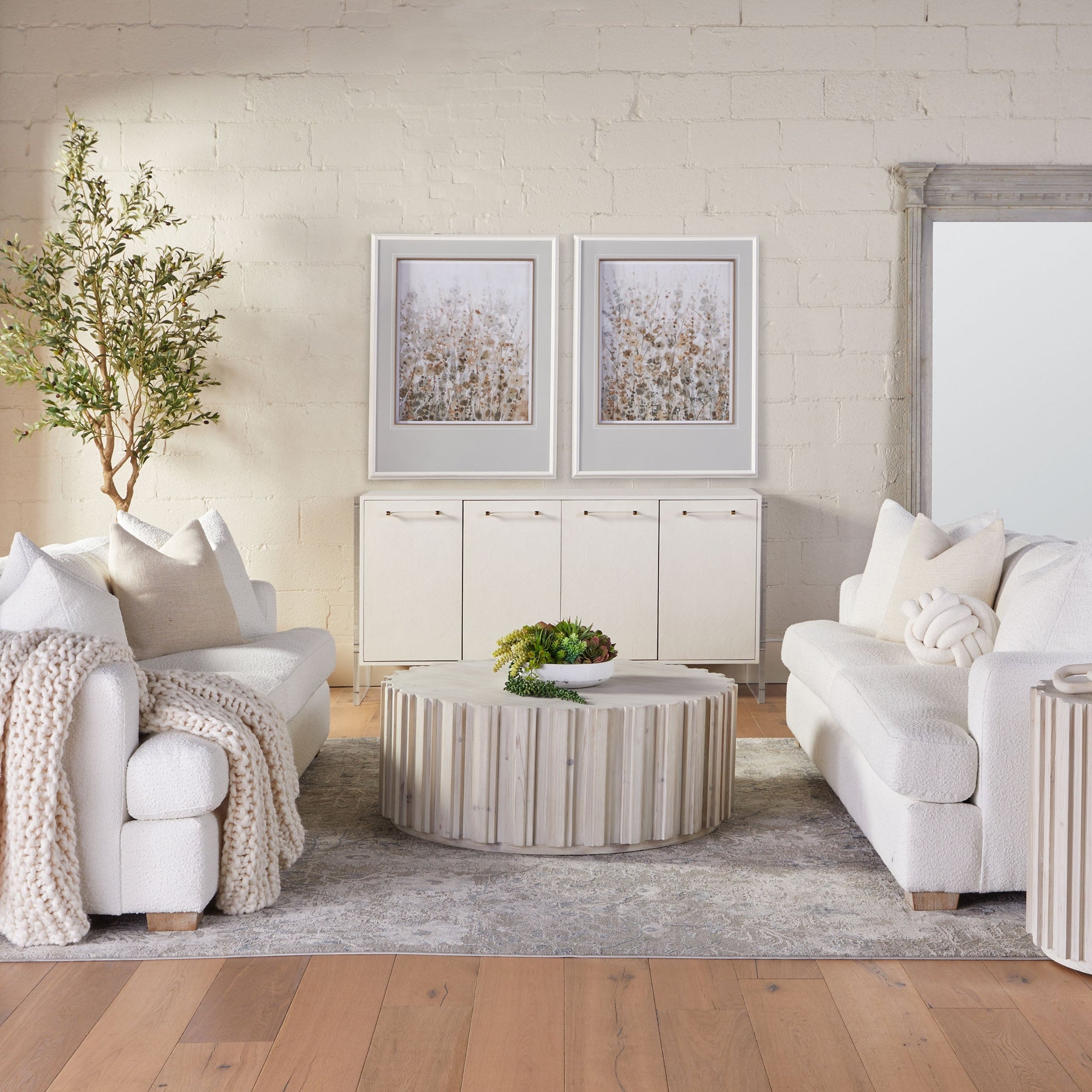 Round Roma Coffee Table with whitewash finish and decorative wood fluting in a cozy living room by Essentials for Living