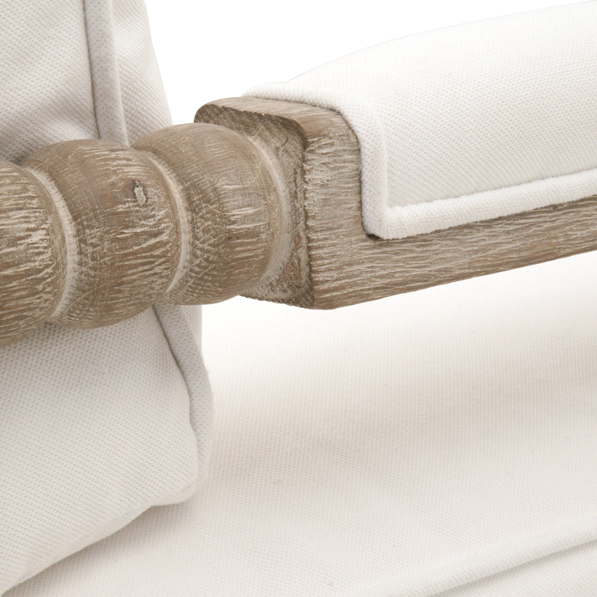 Close-up of solid gray oak spool detail and white upholstered armrest on Rouleau Club Chair by Essentials for Living
