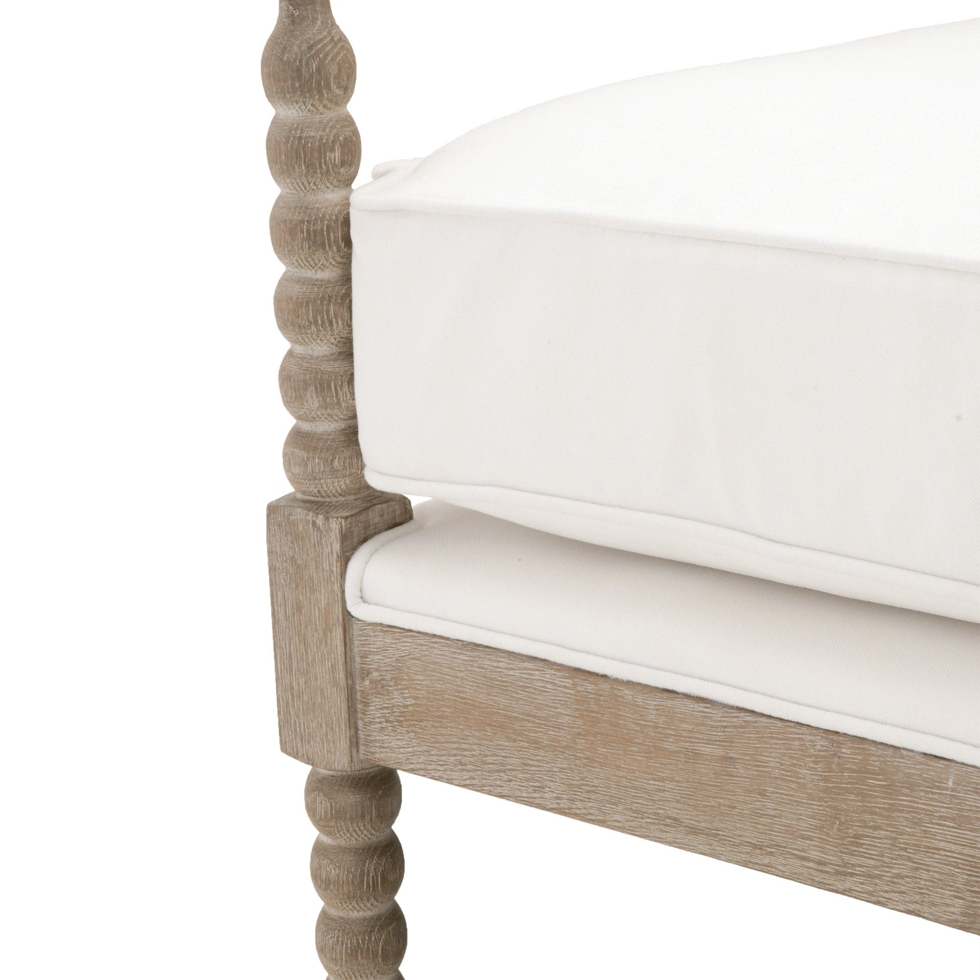 Close-up of Rouleau Club Chair’s carved natural gray oak frame with white upholstered cushions by Essentials For Living