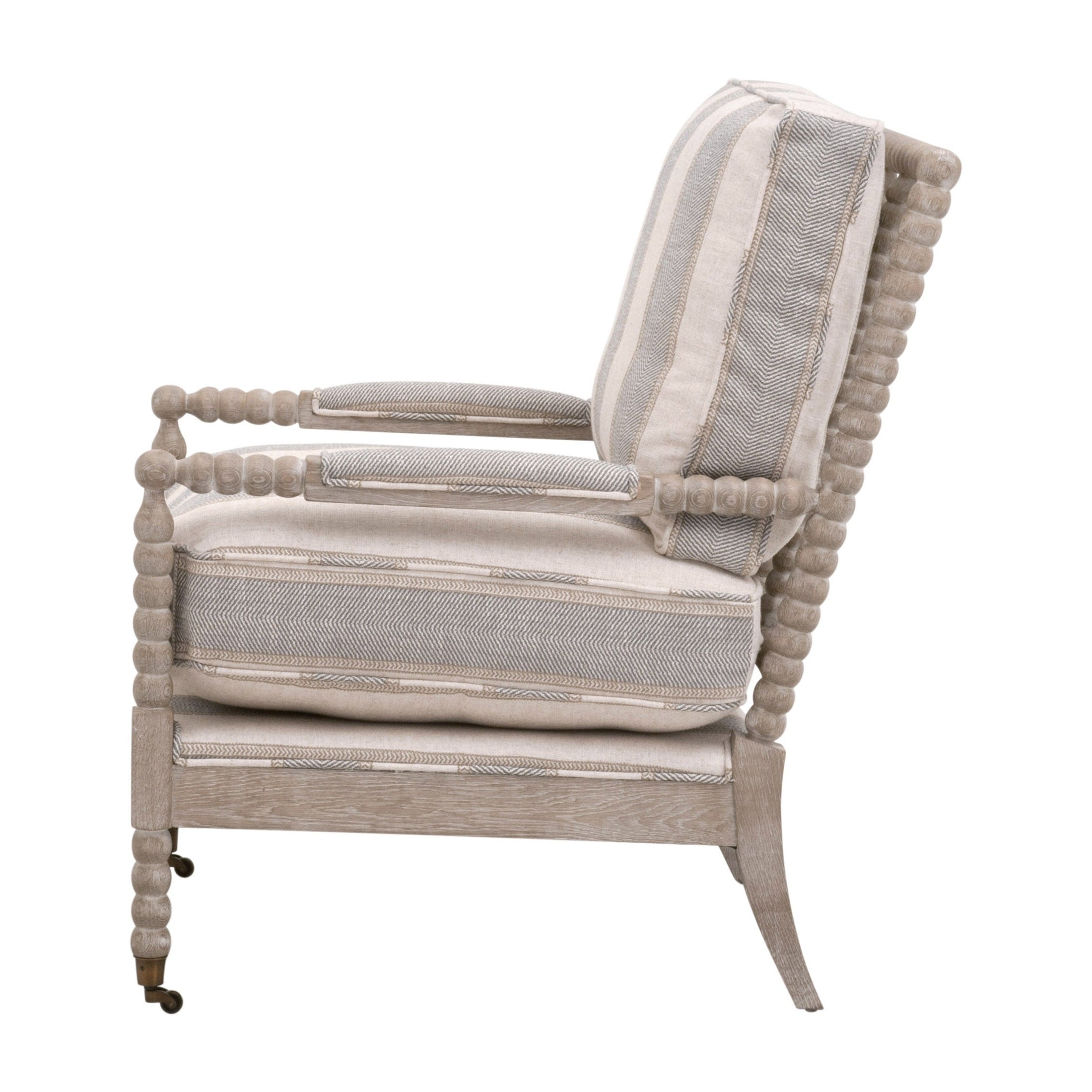 Side view of Rouleau Club Chair by Essentials For Living with carved spool wood frame and striped cushions