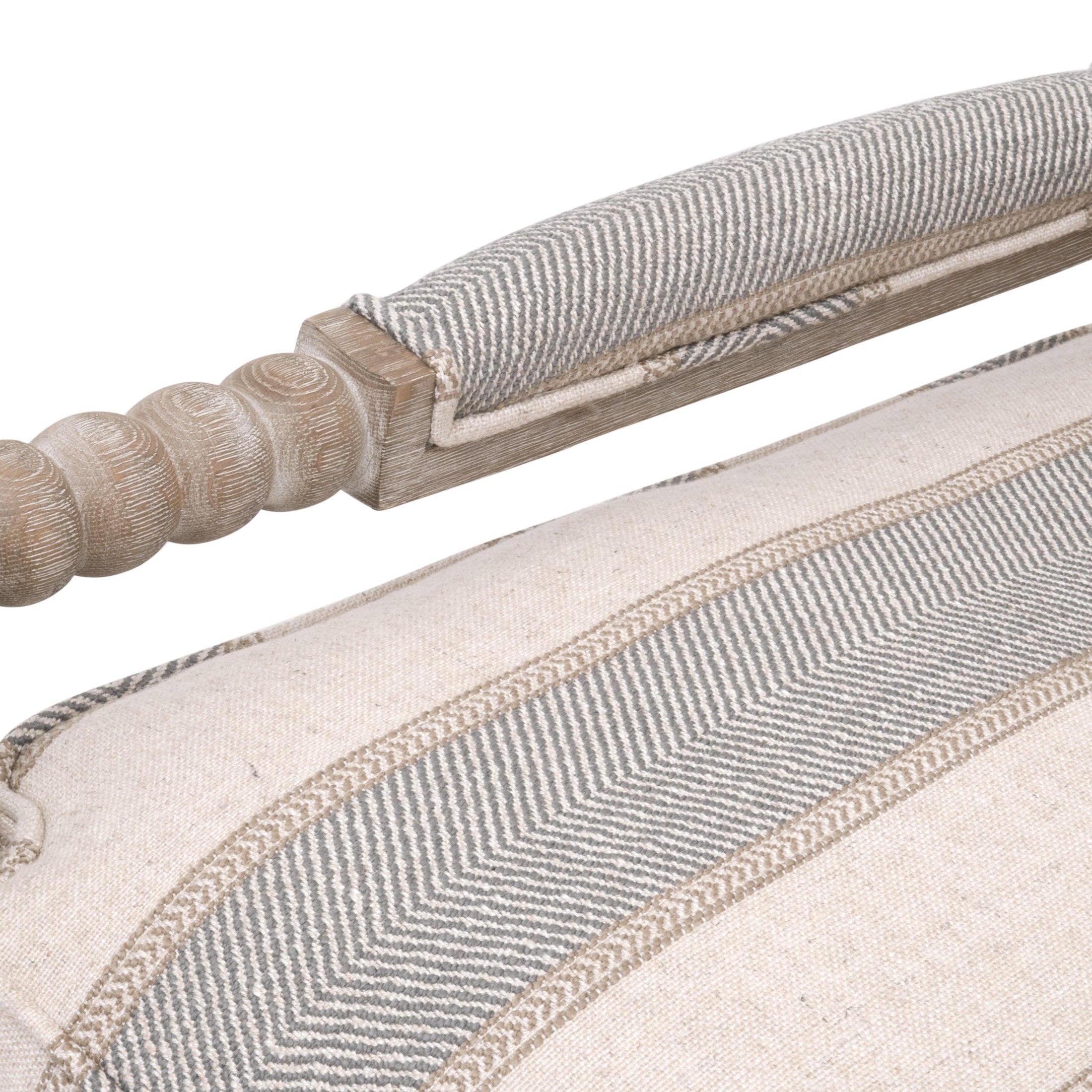 Close-up of Rouleau Club Chair’s carved gray oak frame and textured striped beige upholstery detail by Essentials for Living